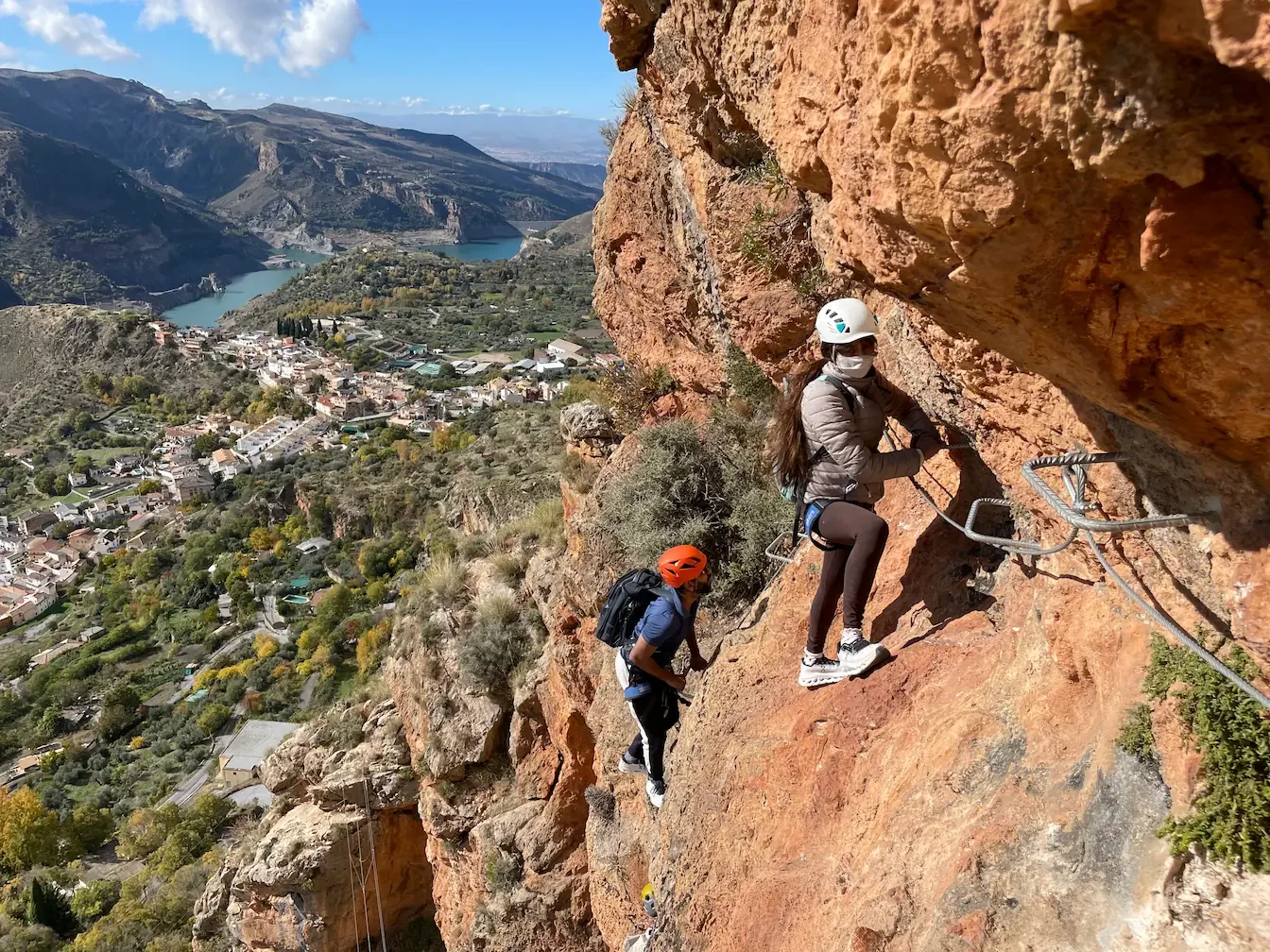 Two person enjoying their first via ferrata guided by a climbing instrctor around Granada