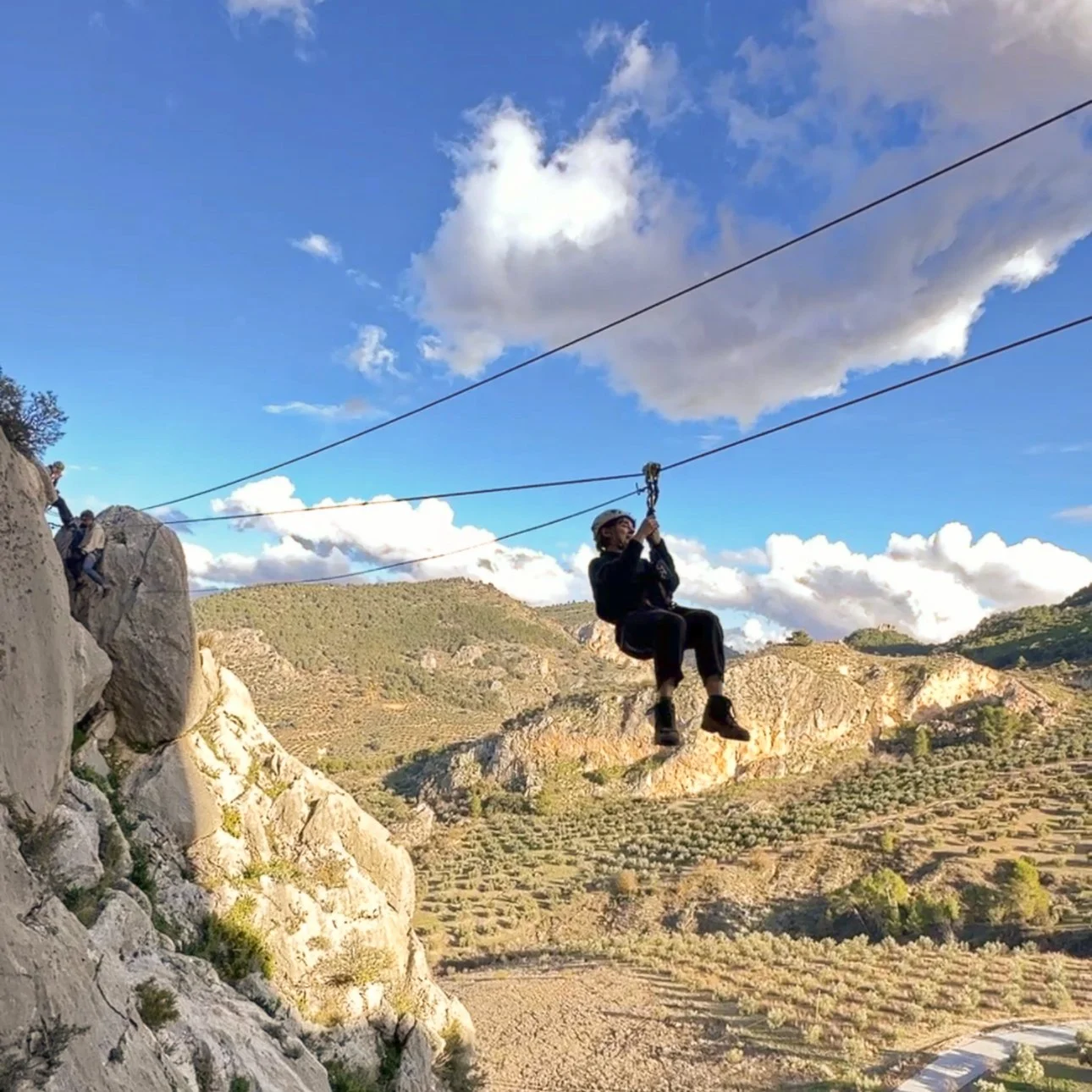 A girl having fun doing a zipline in Andalusia