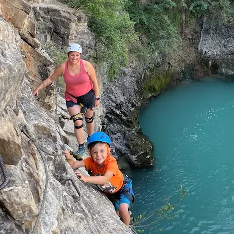 Familly enjoying guide via ferrata above water