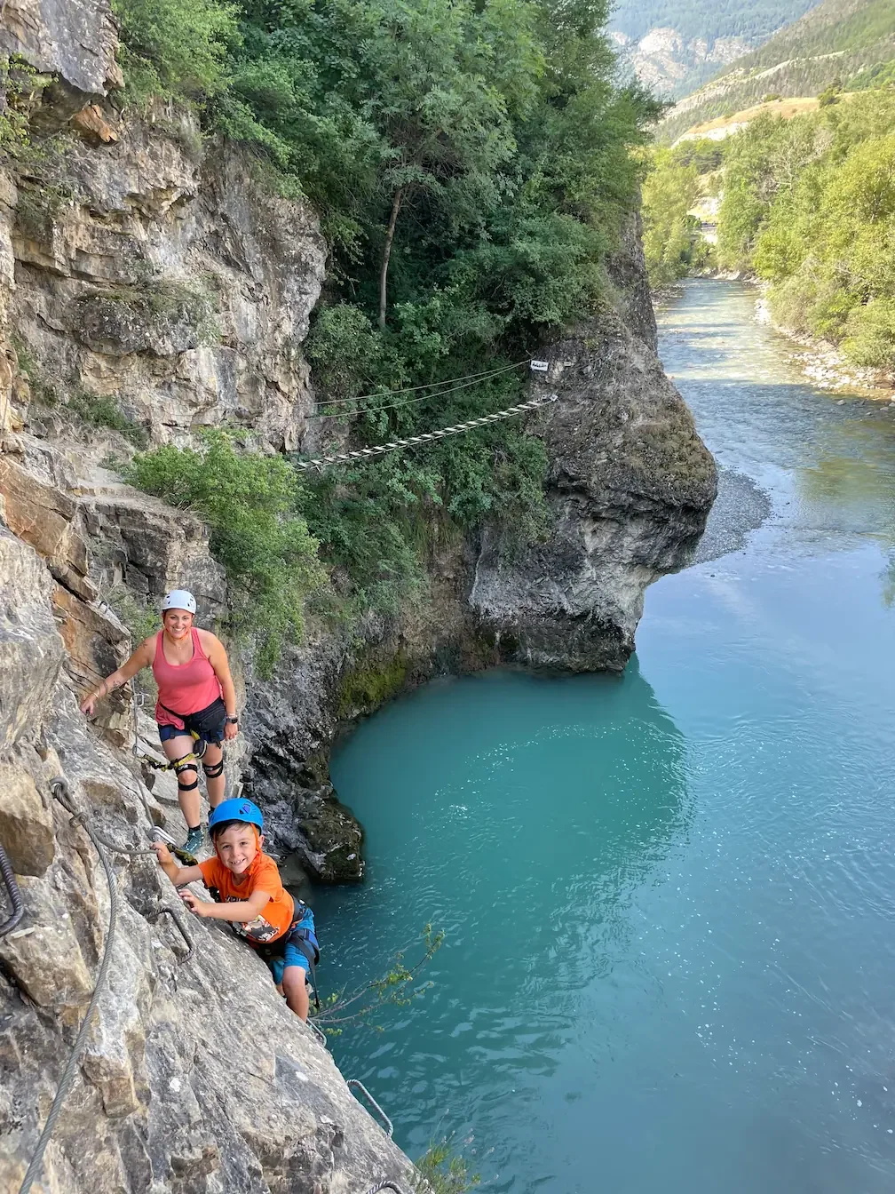 Familly enjoying guide via ferrata above water