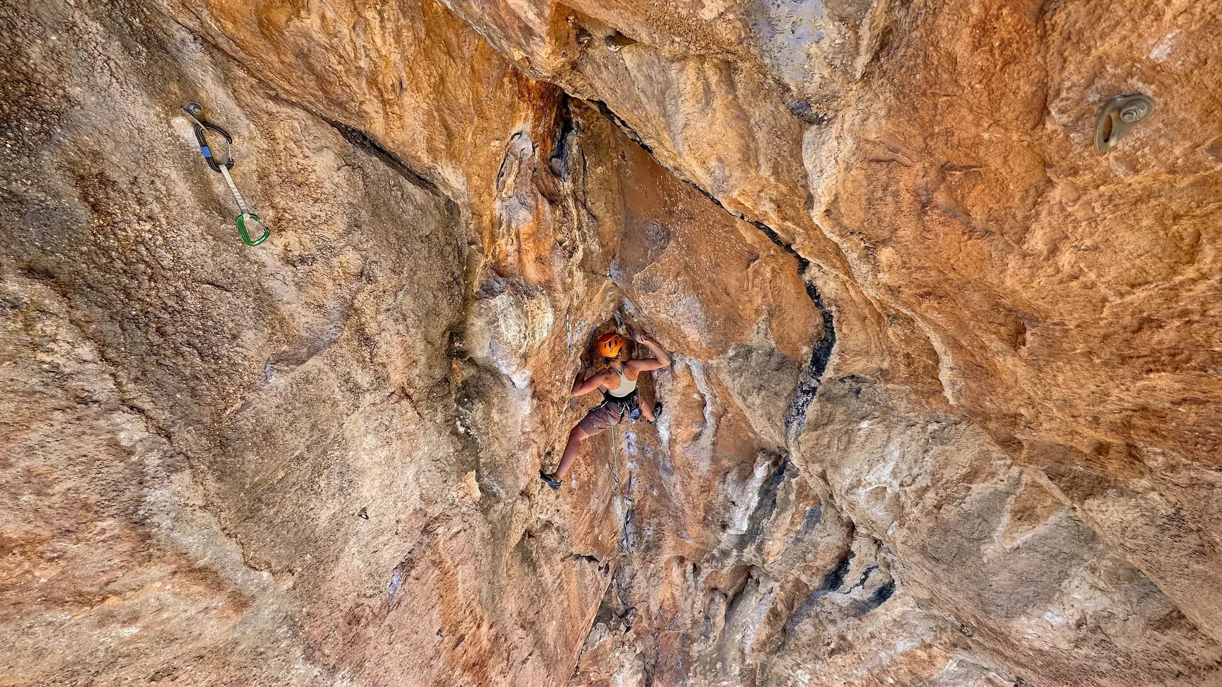 A girl trying her project during an advanced climbing course