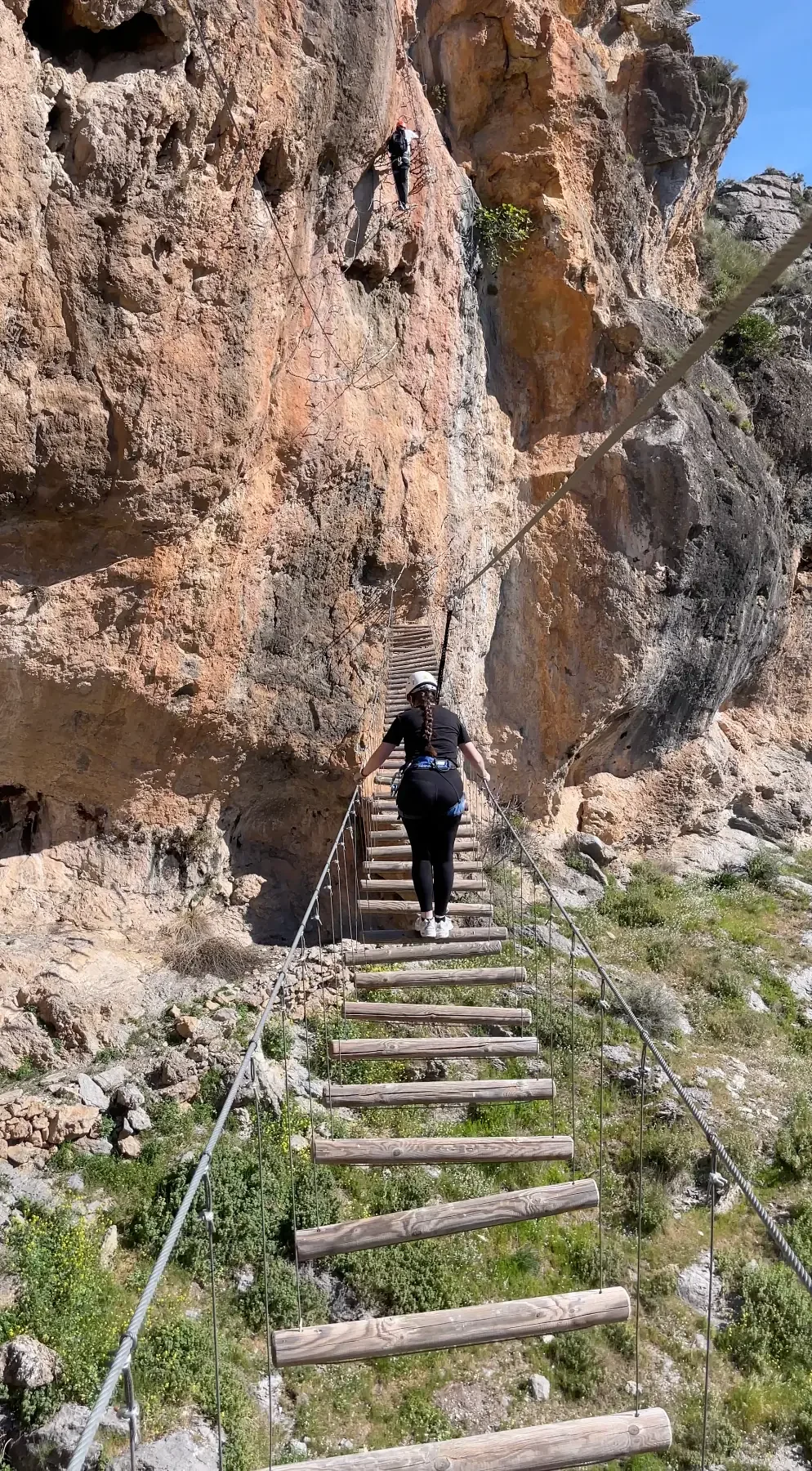 Two persons enjoying the via ferrata of "La Colmena" In Quentar, close to Granada. Akroche Climbing as a guide