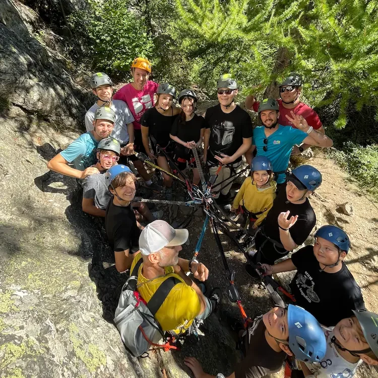 A lot of children wit hdiscapacities are enjoying a via ferrata, smilling