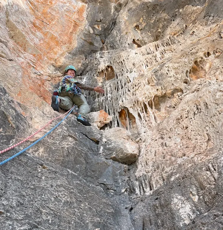 Happy climber climbing on costa blanca's tufas