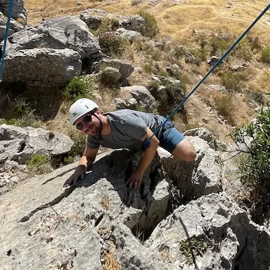 A guy enjoying his first rock climbing course in andalusia