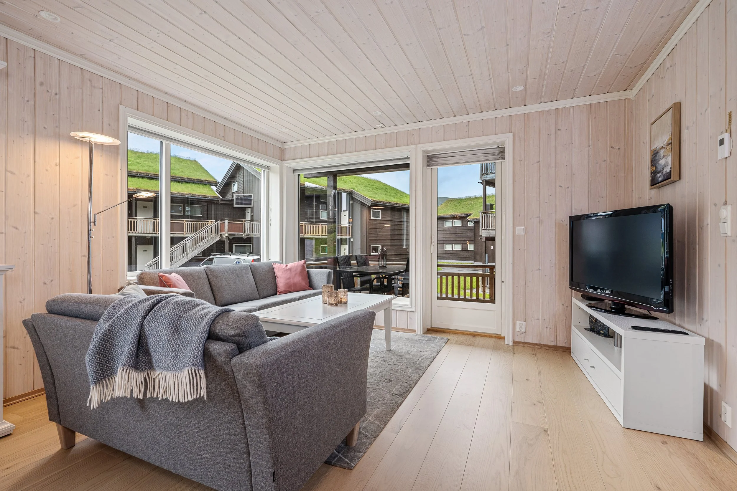 Open living room and kitchen, with dining table. Photo