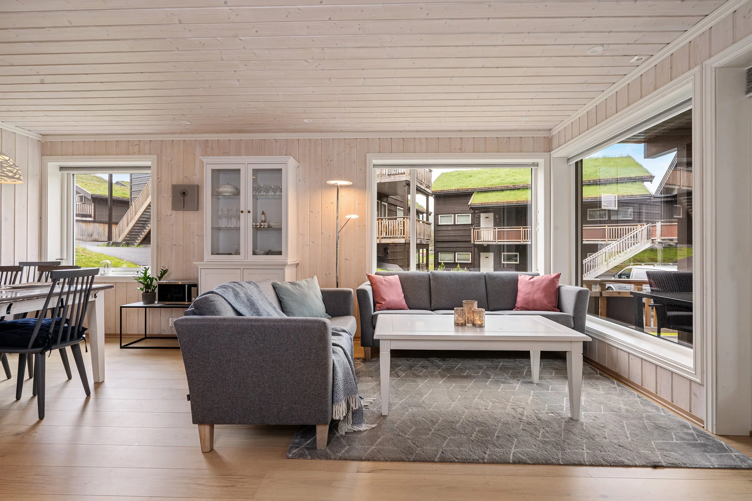 Bright, open living room with large windows. Photo