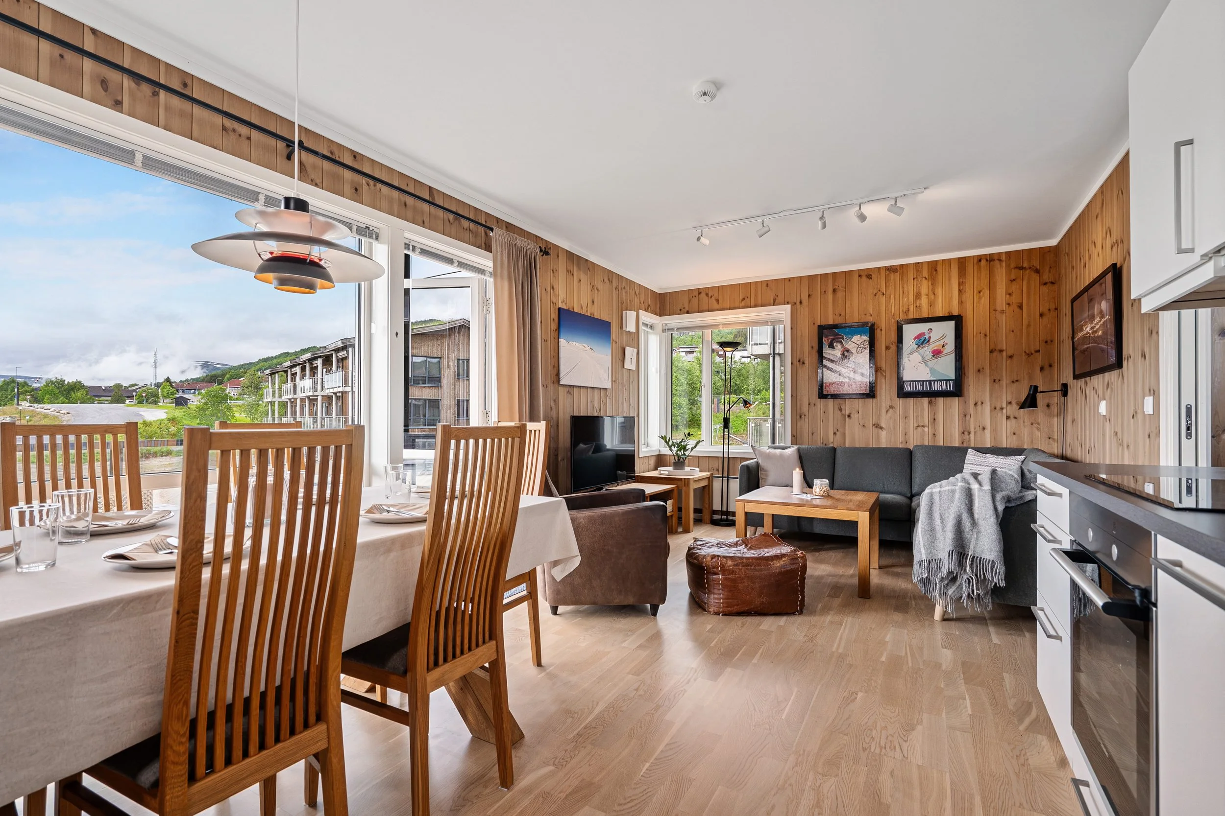 Open living room and kitchen with dining table and sofa. Photo