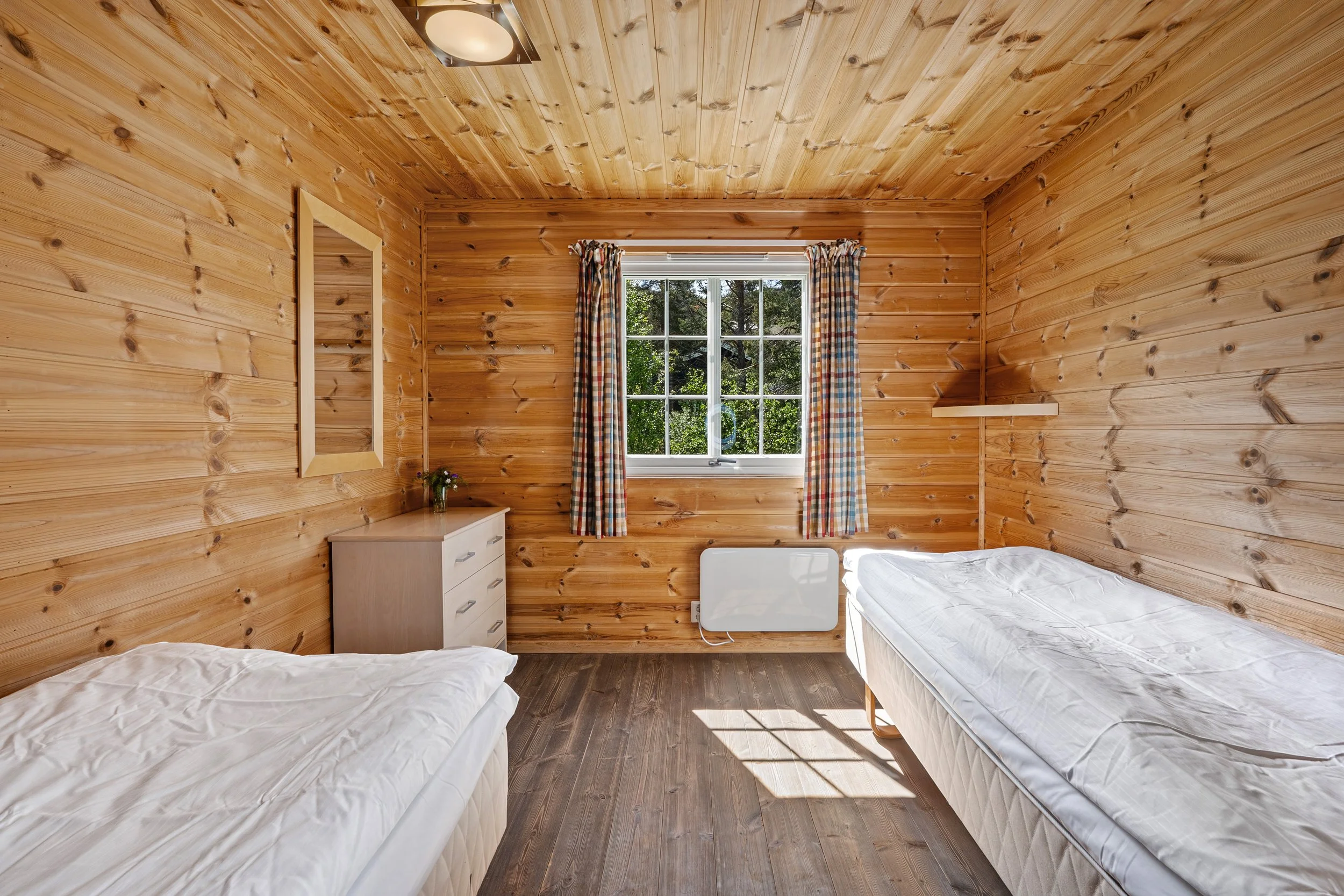Bedroom with two single made-up beds. Photo