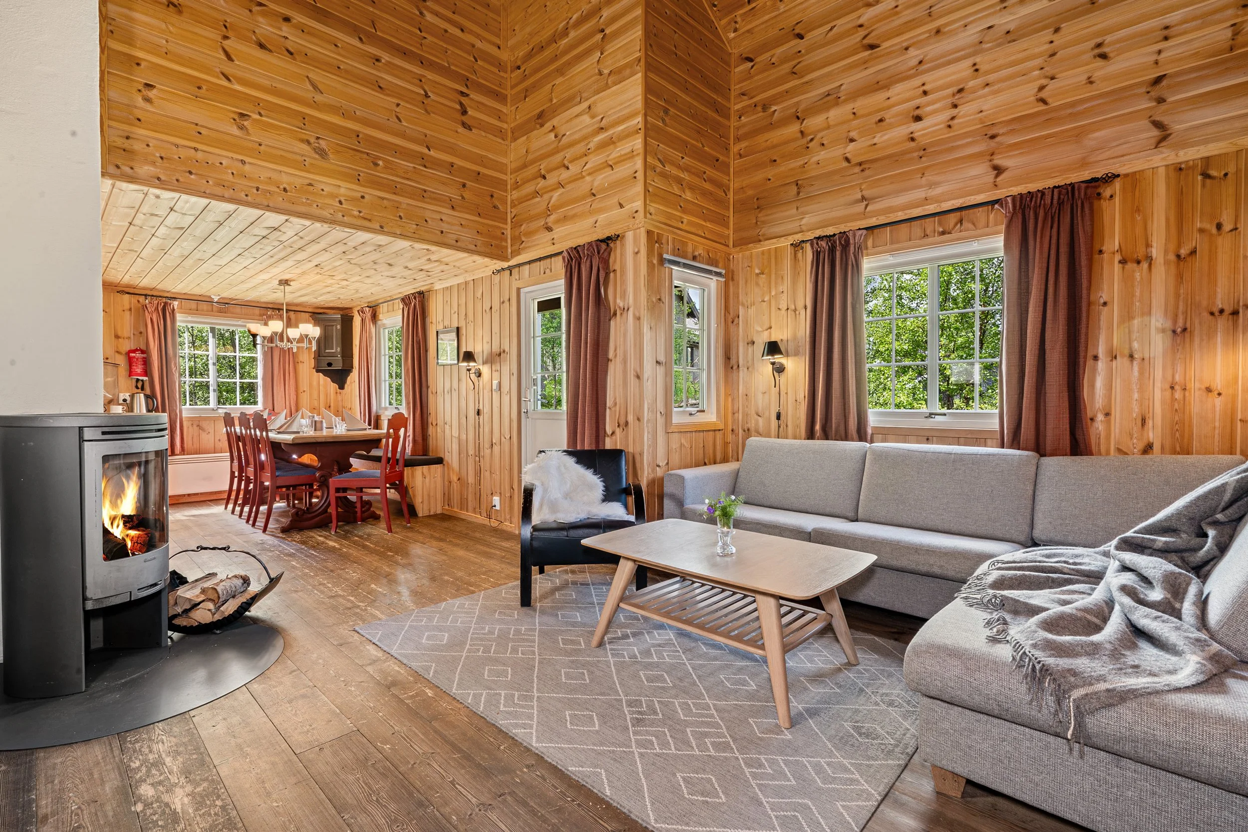 Open plan living and kitchen in a traditional cottage. Fireplace and cozy sofa area. Photo
