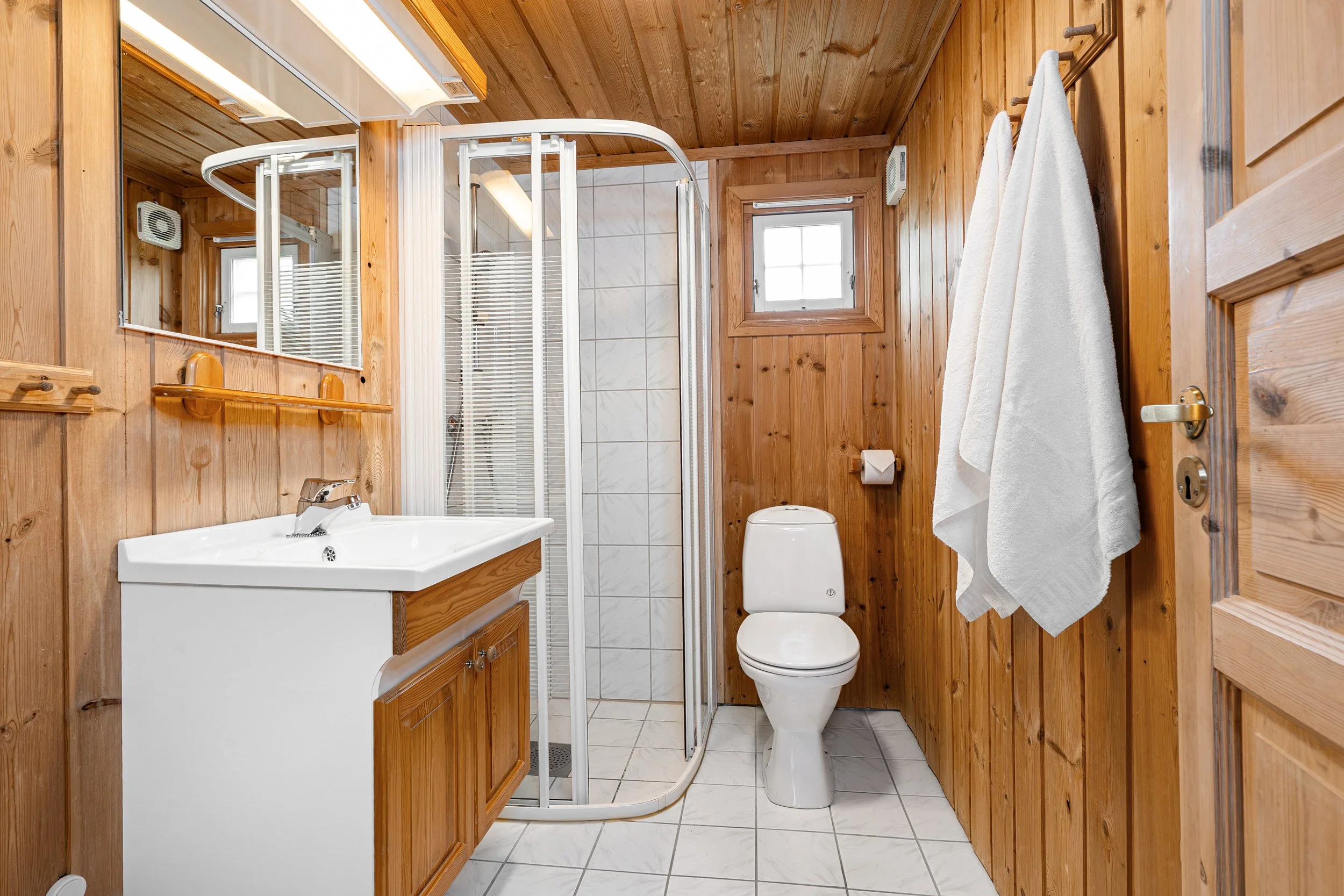 Bathroom with shower, toilet and sink. Photo