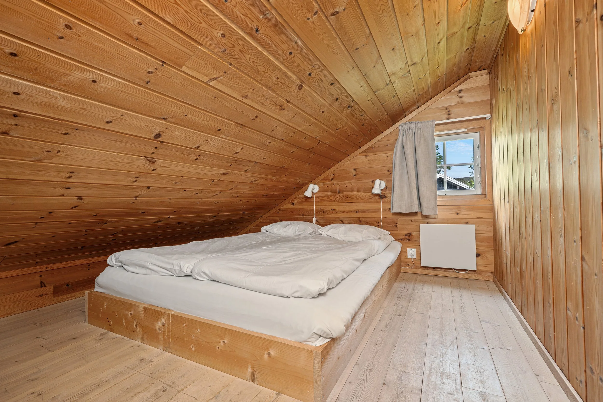 Bedroom on the loft with a low double bed. Photo