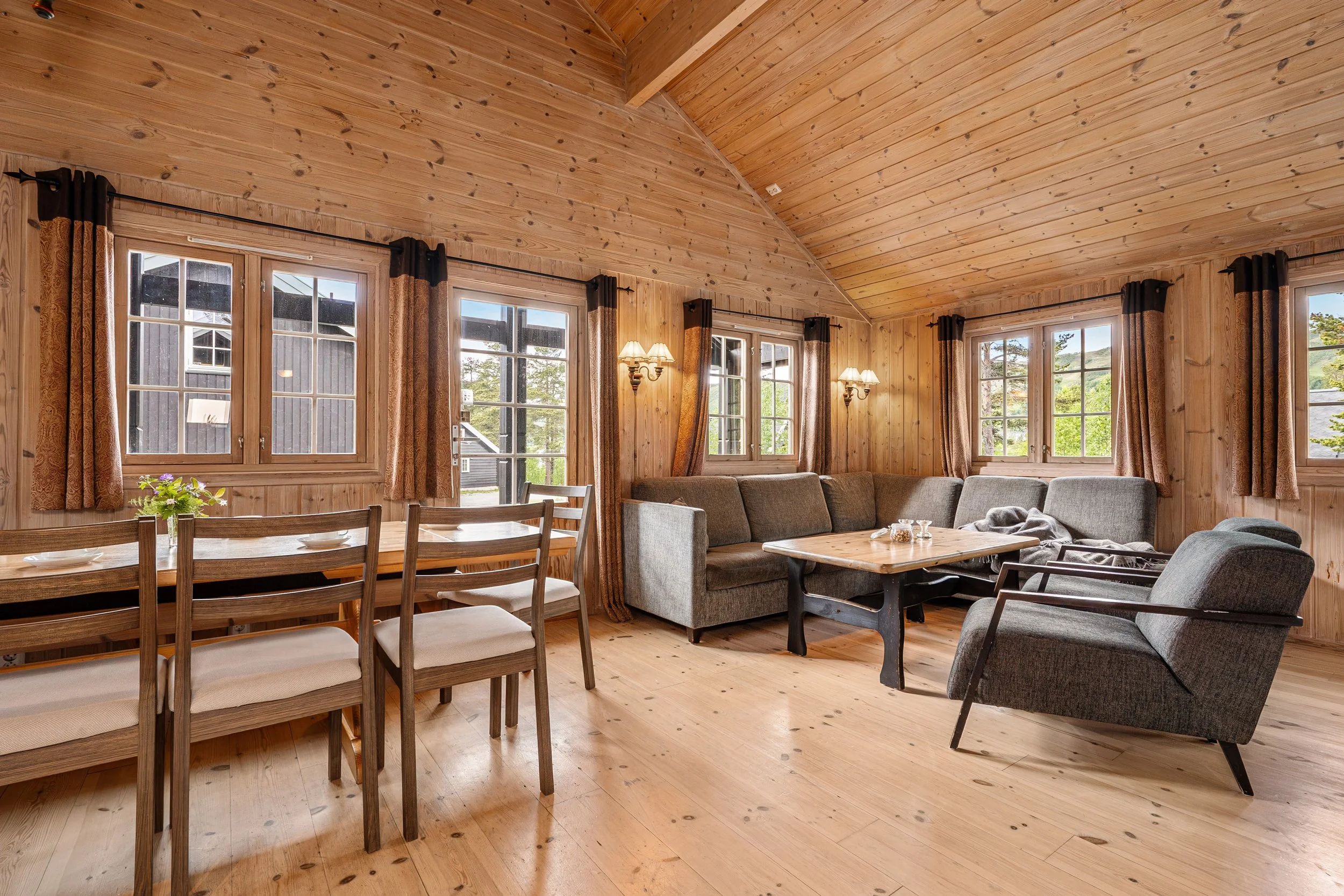 Dining table and sofa corner in open living room and kitchen. Photo