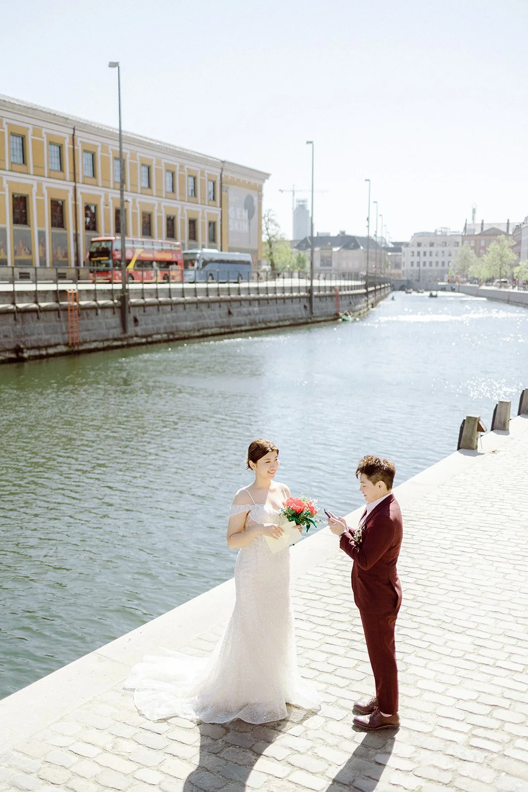 Wedding couple exchange vows by canal in copenhagen same sex LGBTQ emotional denmark.jpg
