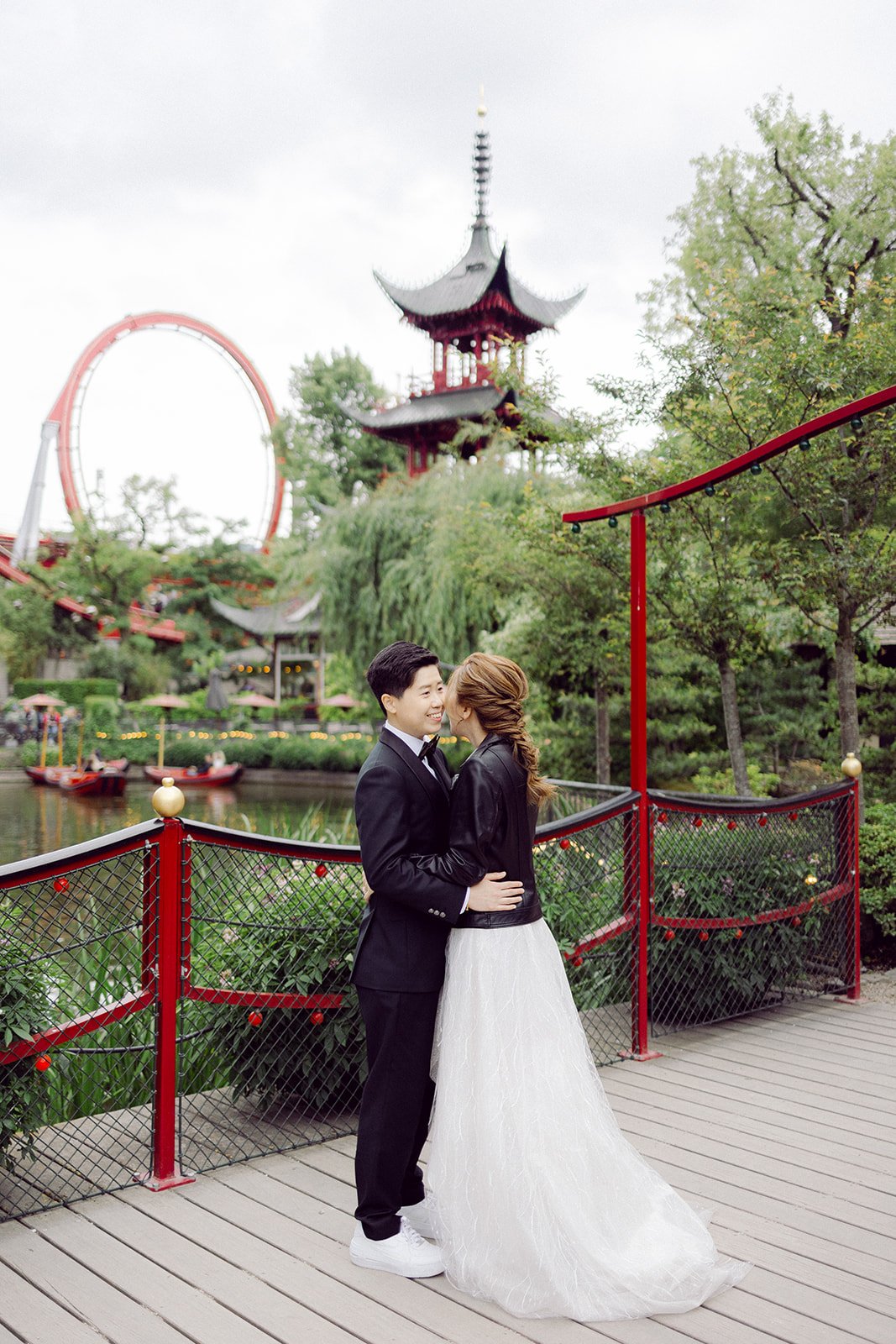 same sex LGBTQ couple hugging kissing in Tivoli garden after getting married in copenhagen city hall.jpg