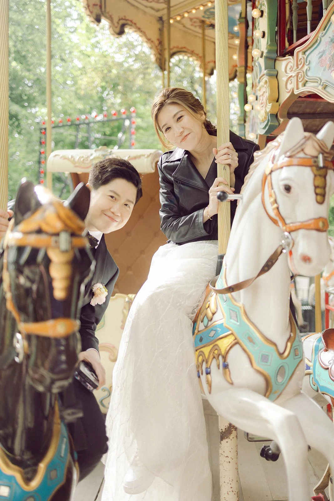 same sex LGBTQ couple in Tivoli Carousel after getting married in copenhagen city hall.jpg