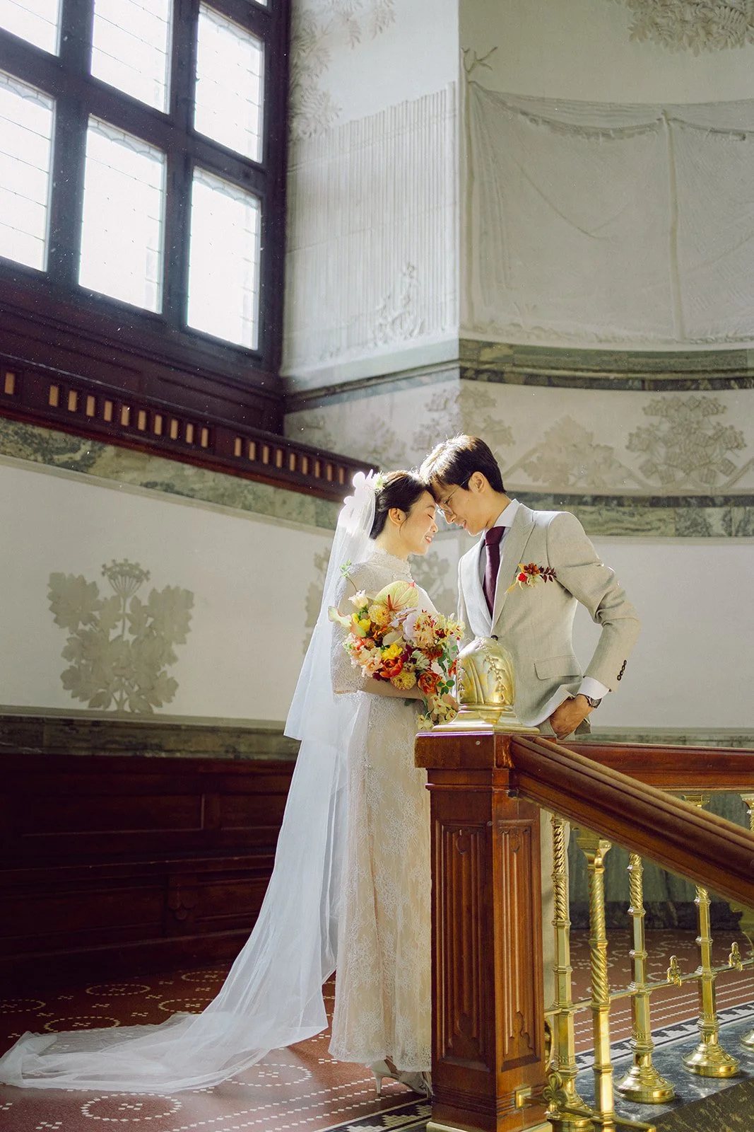 Bride and groom portrait sunny day pose in copenhagen city hall after getting married in denmark.jpg