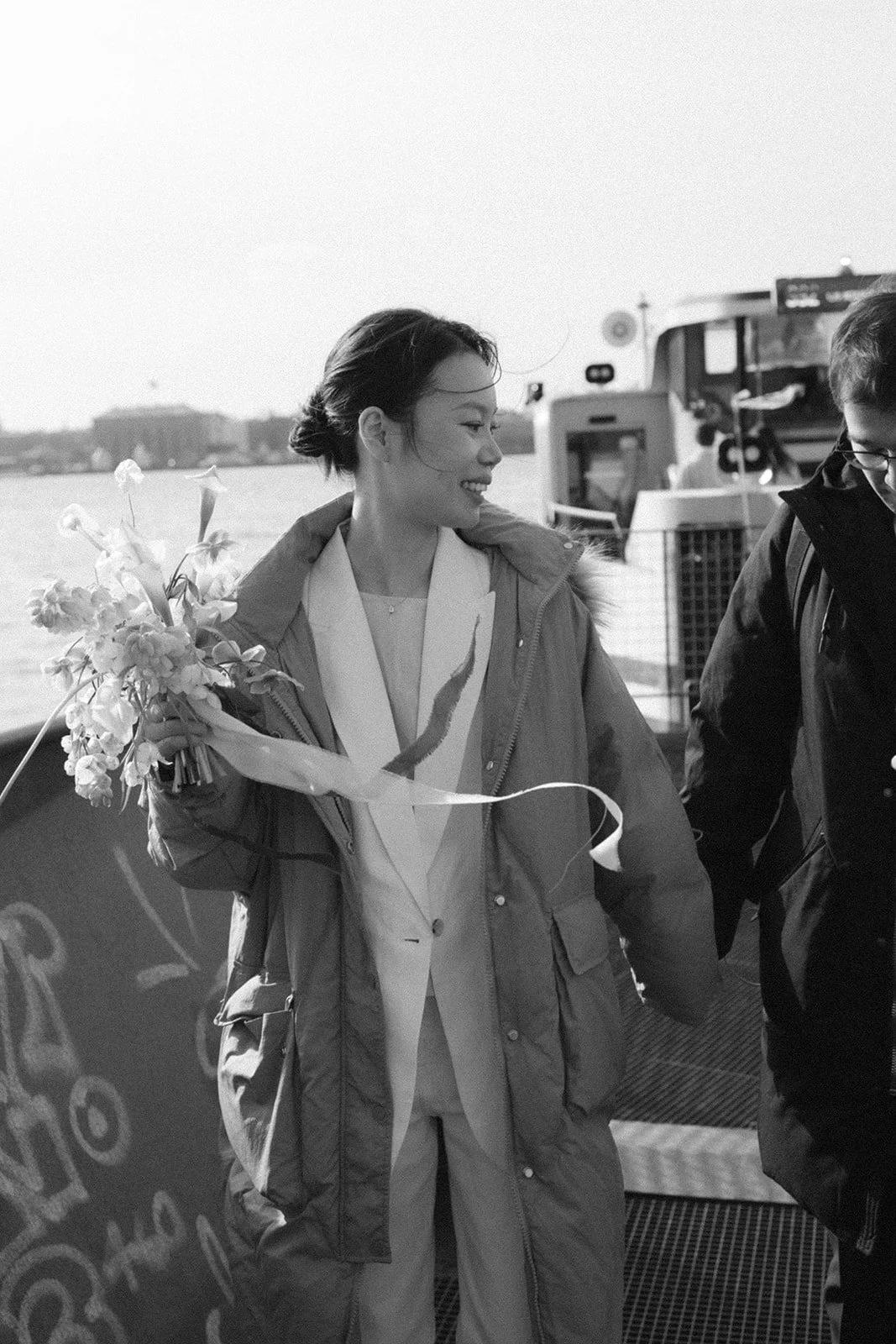 Bride and groom get off waterbus after getting married in denmark in copenhagen.jpg
