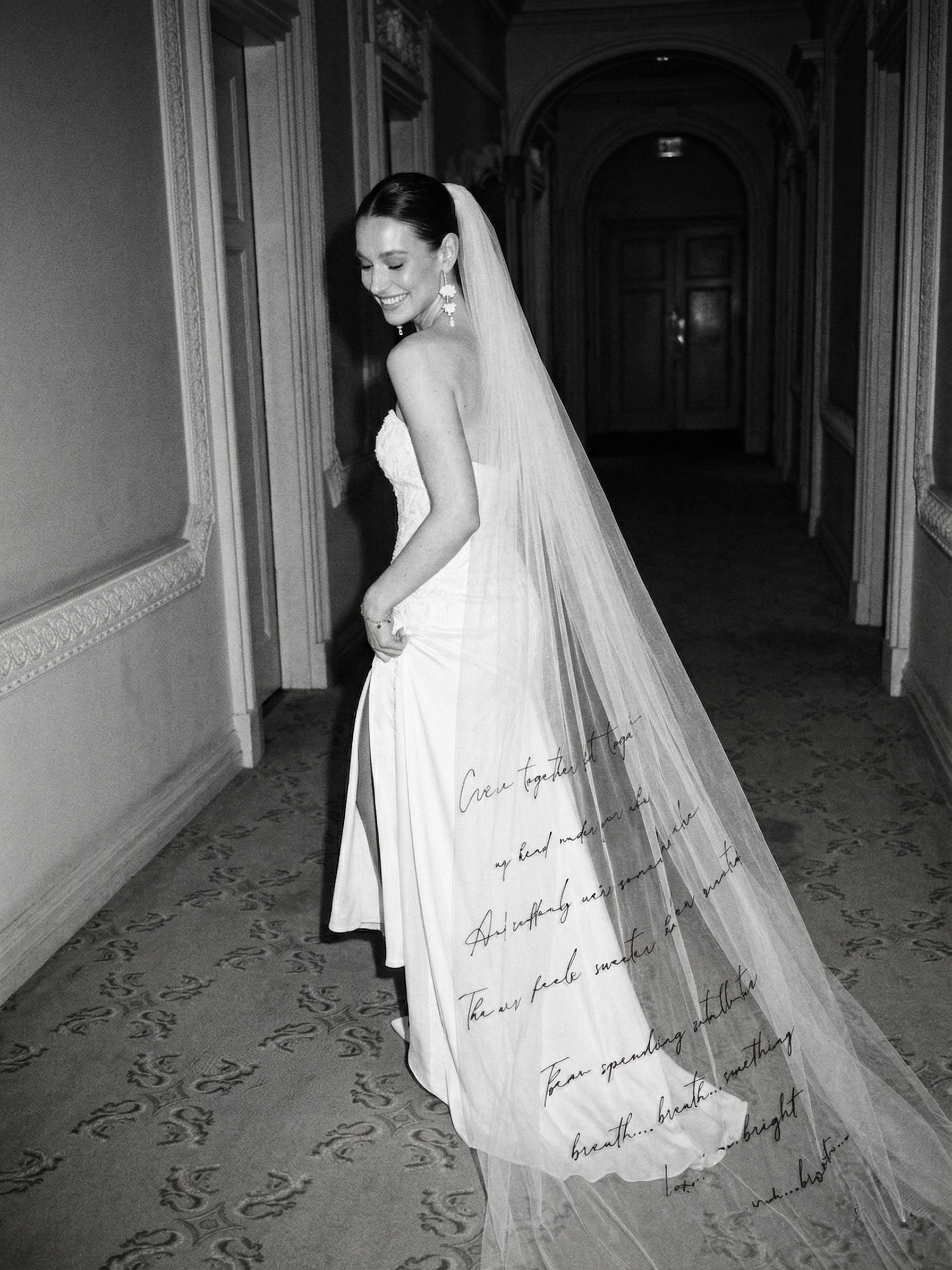 bride having designer veil with letters on smiling in hotel hall way elegant luxury