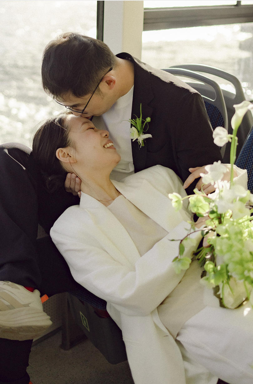 couple kissing in the boat in copenhagen city hall wedding in denmark on the canal