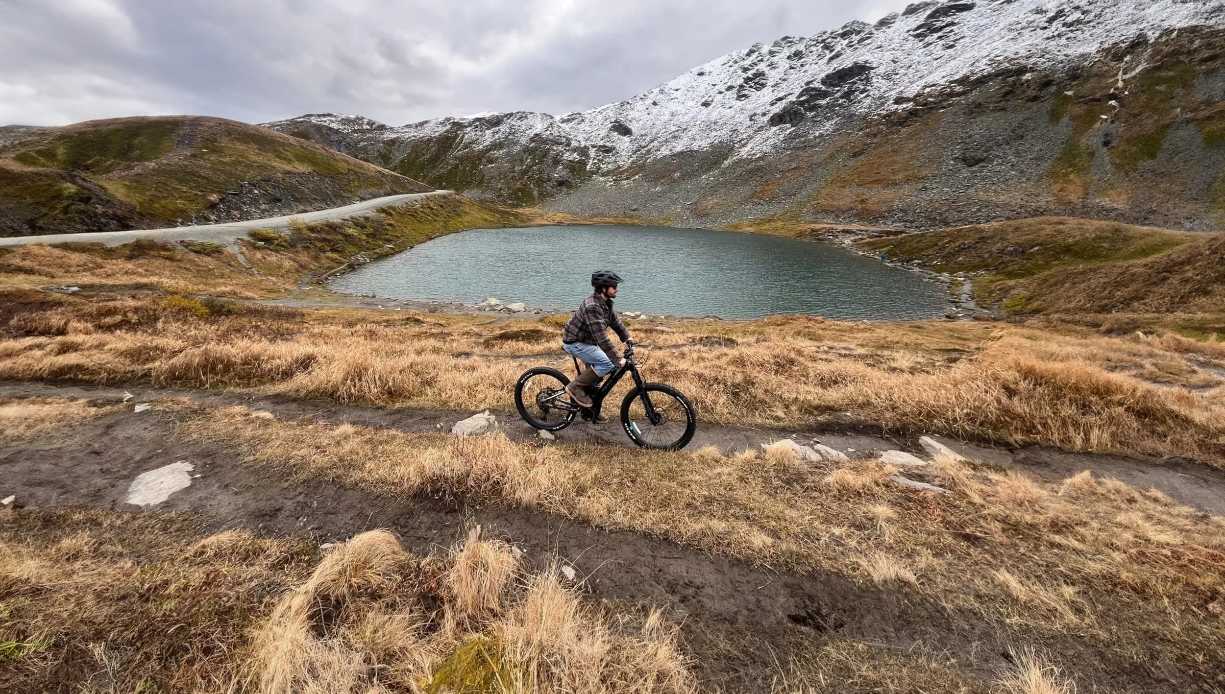 Man By Small Lake On Bike.jpg