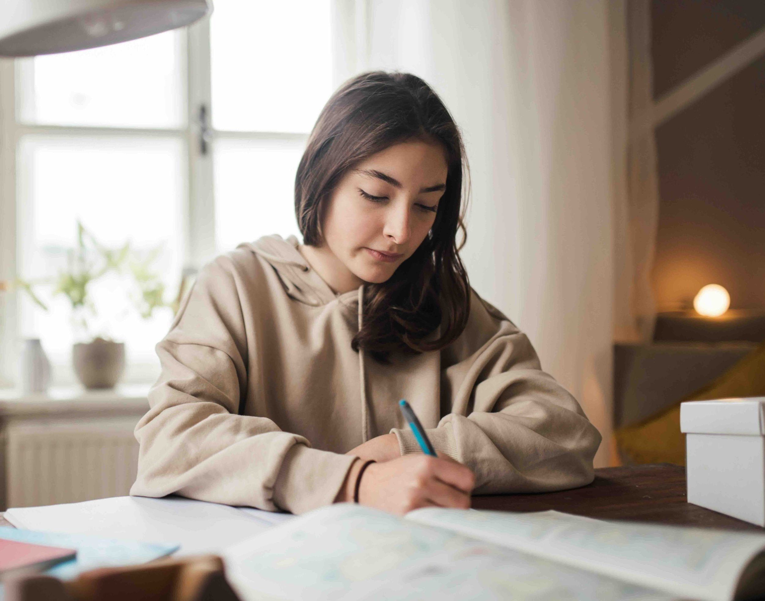 Secondary school girl writing on a notepad