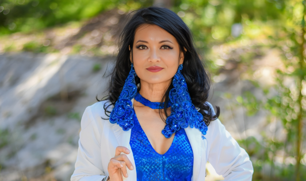Fashion creator wearing a white jacket and blue accessories