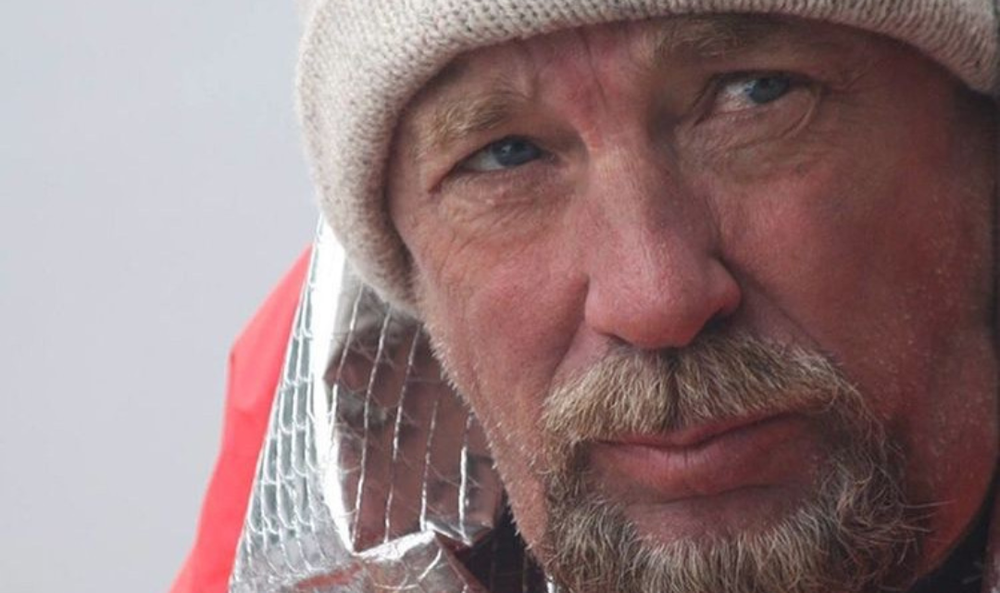 Outdoor creator wearing a knit hat and red jacket