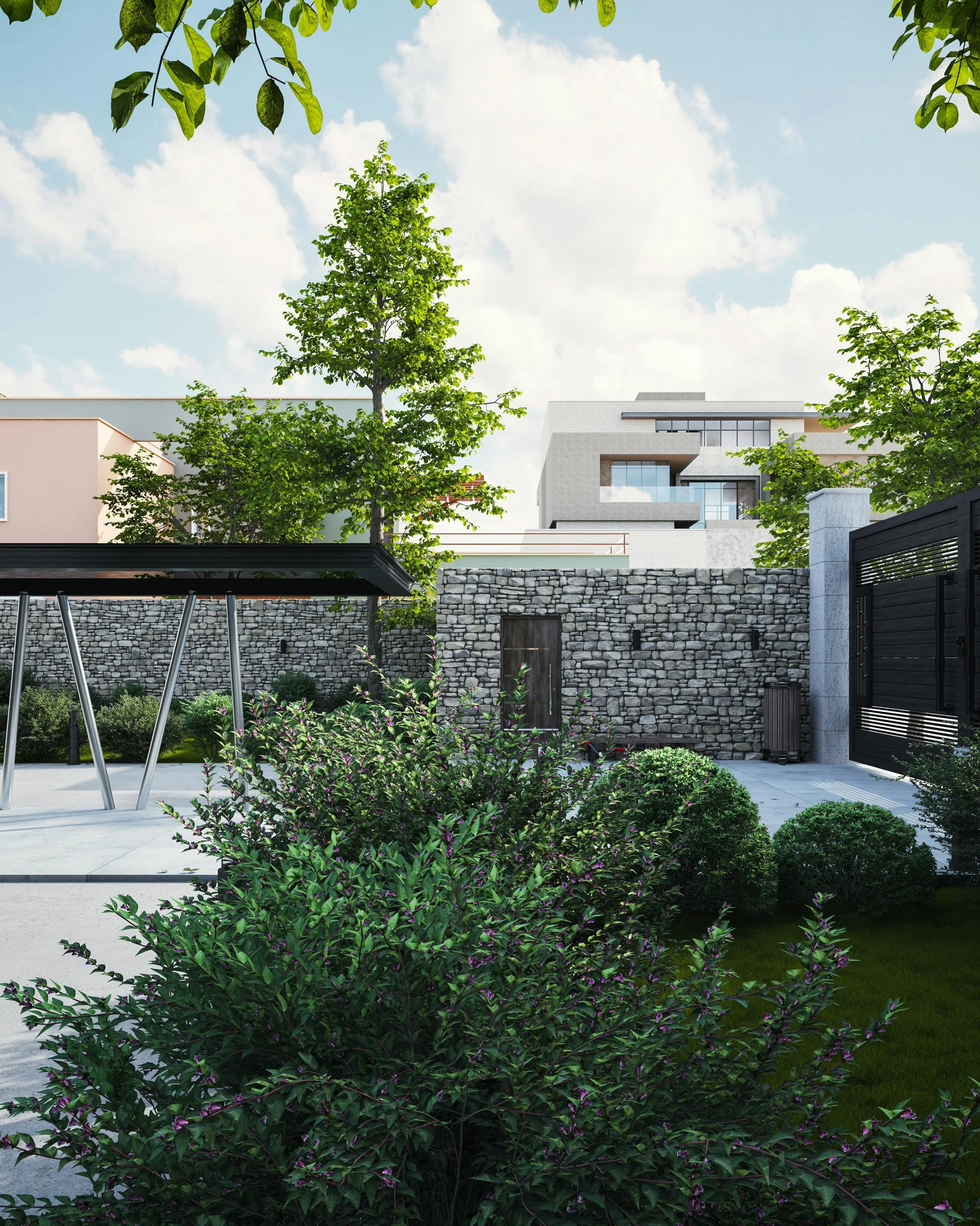 A modern backyard with a stone wall, lush green bushes, trees, a black metal gate, and a patio with a table and chairs, under a bright sky with scattered clouds.