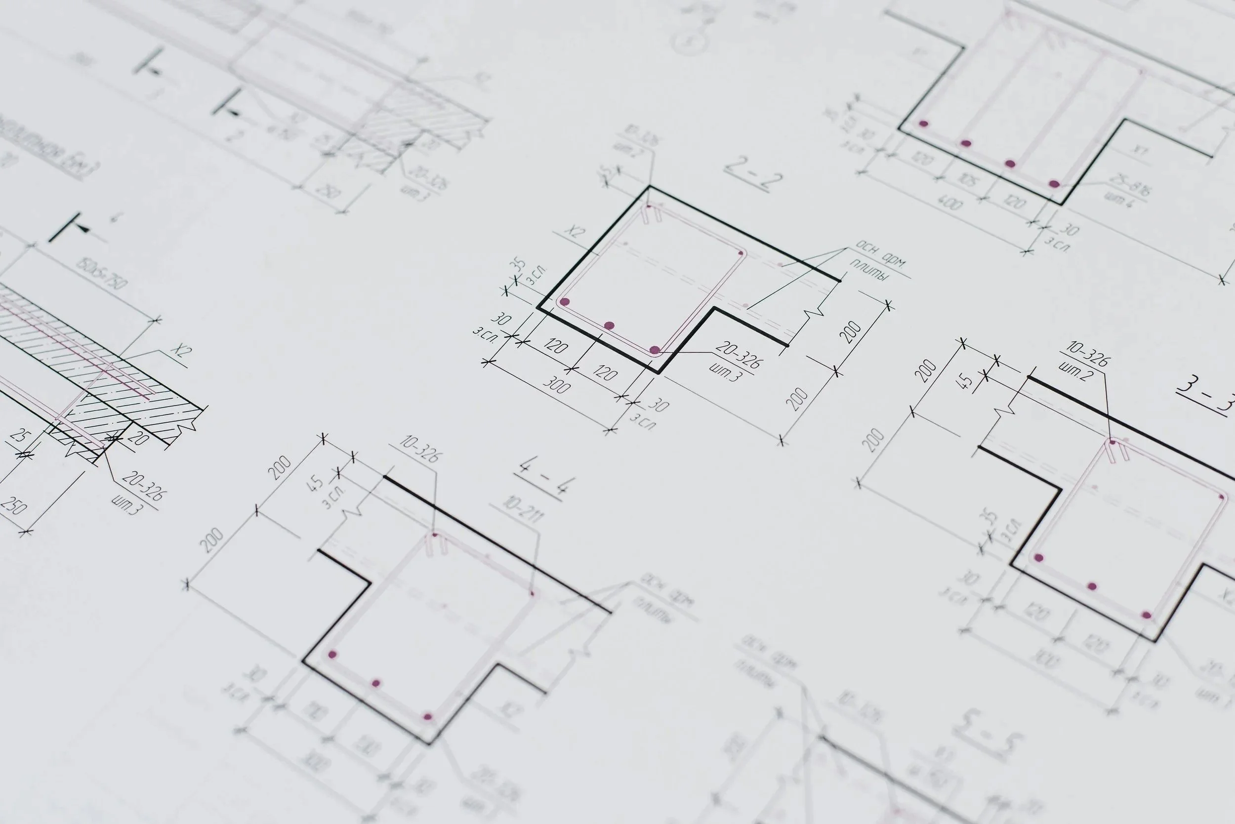 Architectural blueprint with detailed floor plans and measurements in black, pink, and green ink.