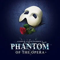 A white ghost-like mask with eye holes and a beak-like nose, resting on a dark surface with a red rose, is featured on the poster for 'Phantom of the Opera' with text and credits.
