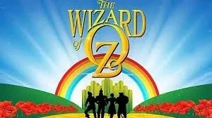 Cover of The Wizard of Oz with a rainbow, yellow brick road, and four characters in silhouette.