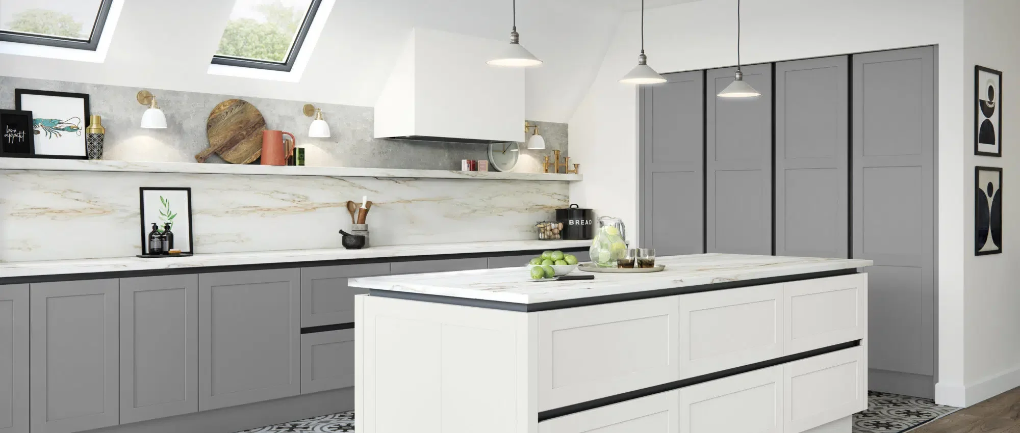 Modern kitchen with grey cabinets, white marble countertops, and a white and grey island. Skylights allow natural light. Decor includes framed artwork, a cutting board, and kitchen accessories. Pendant lights hang over the island.