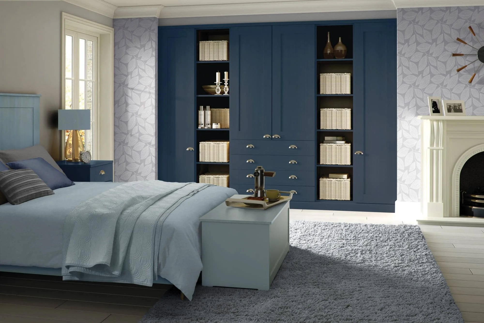 A bedroom with a bed, nightstand, blue wardrobe with baskets, and a fireplace with framed photos and wall decor.