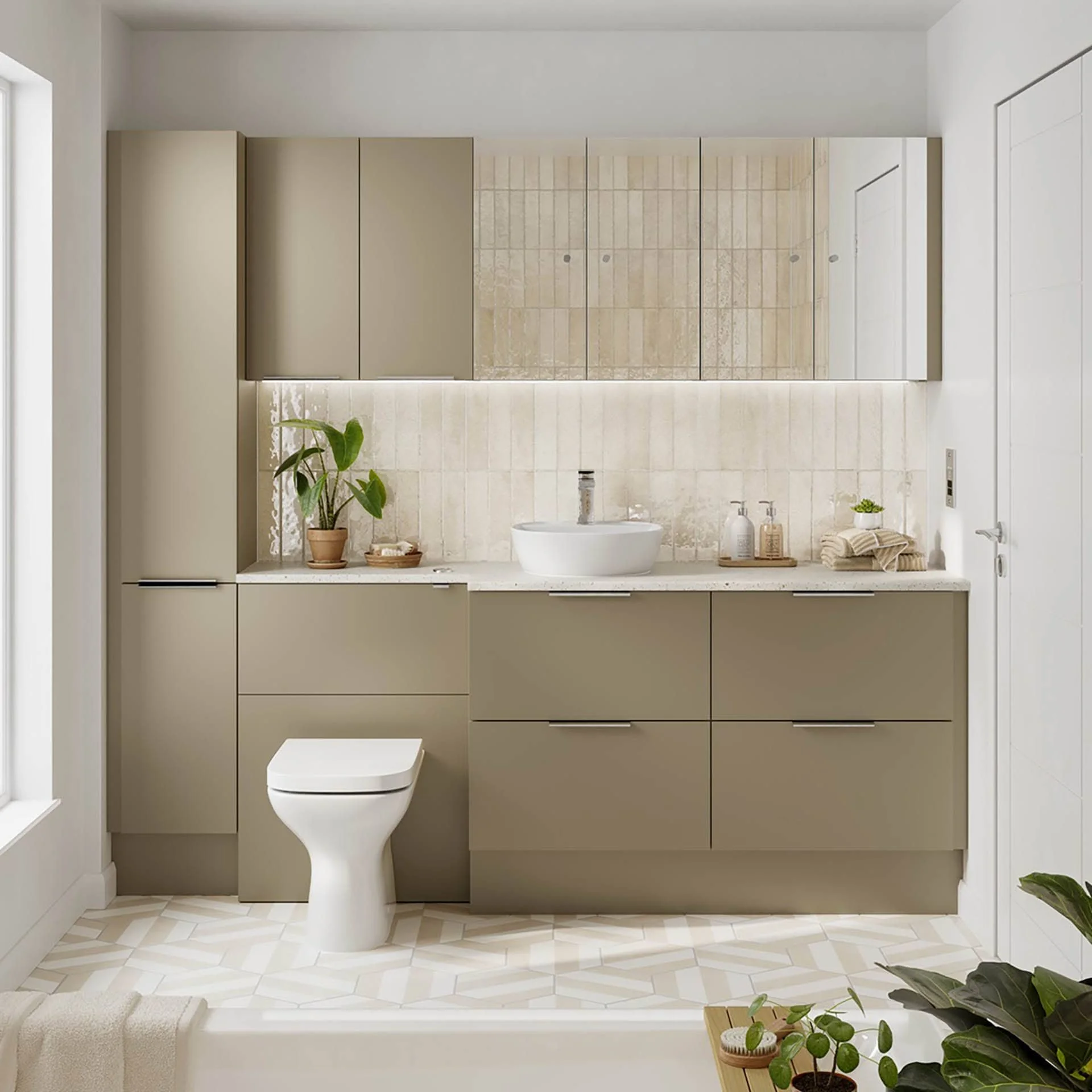 Modern bathroom with beige cabinetry, white countertop, potted plant, bowl sink, and mirror with built-in lighting.