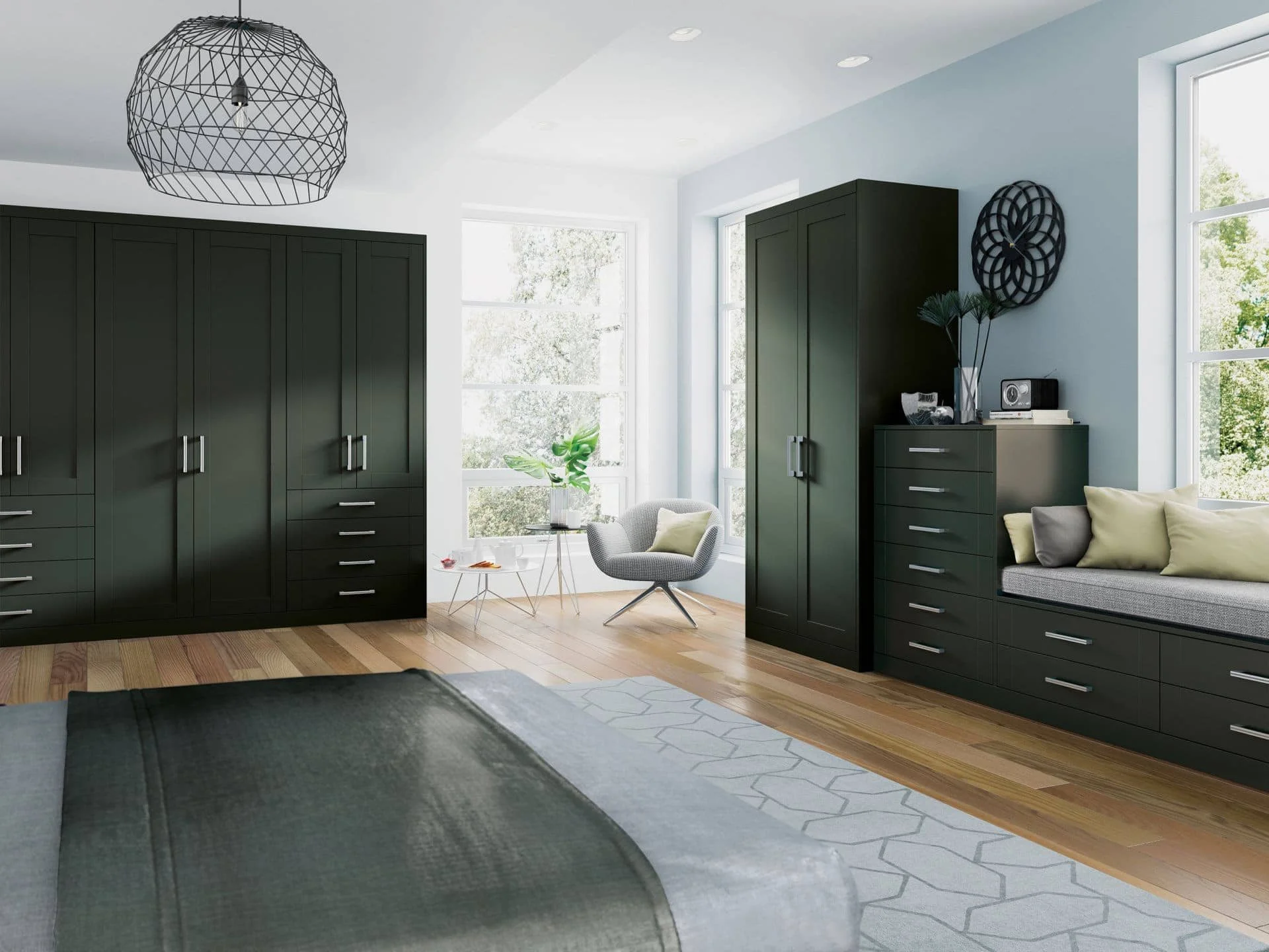 Modern bedroom with black cabinets, a white armchair near windows, and a bench with pillows, wooden floor, and a geometric pendant light.