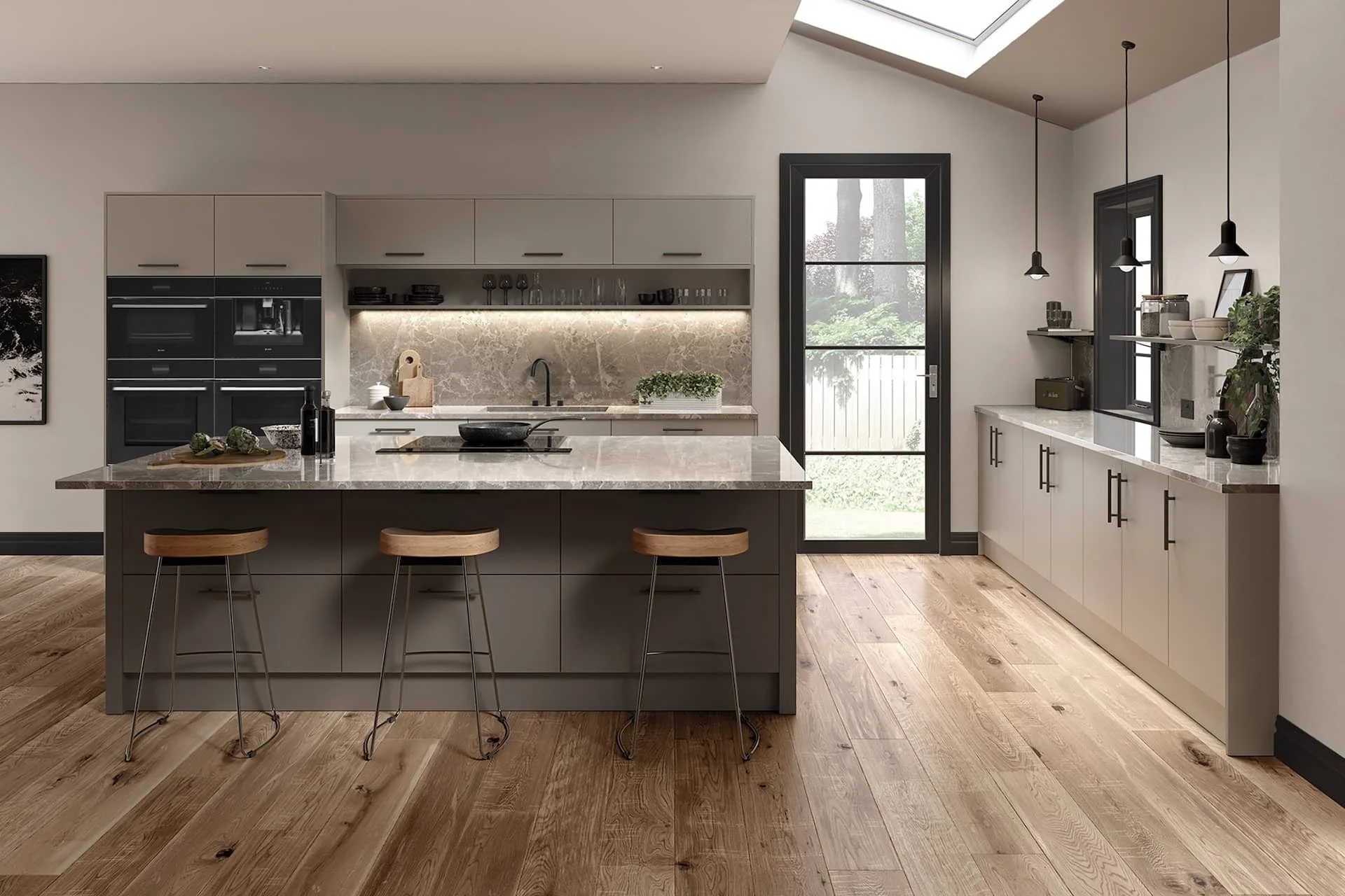 Modern kitchen with island, wooden bar stools, cabinetry, plants, and a door leading outside, natural light streaming in.