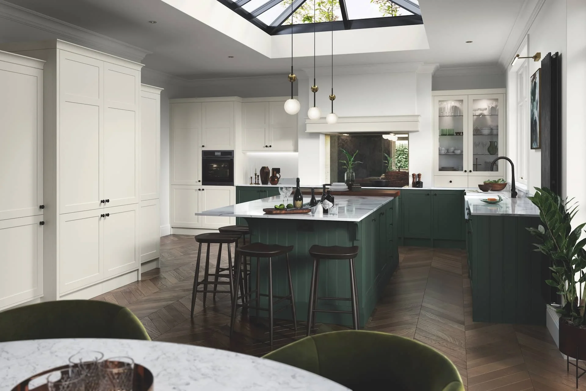 Modern kitchen with a white ceiling and cabinetry, green island with a marble countertop, black barstools, a skylight, and wood flooring.