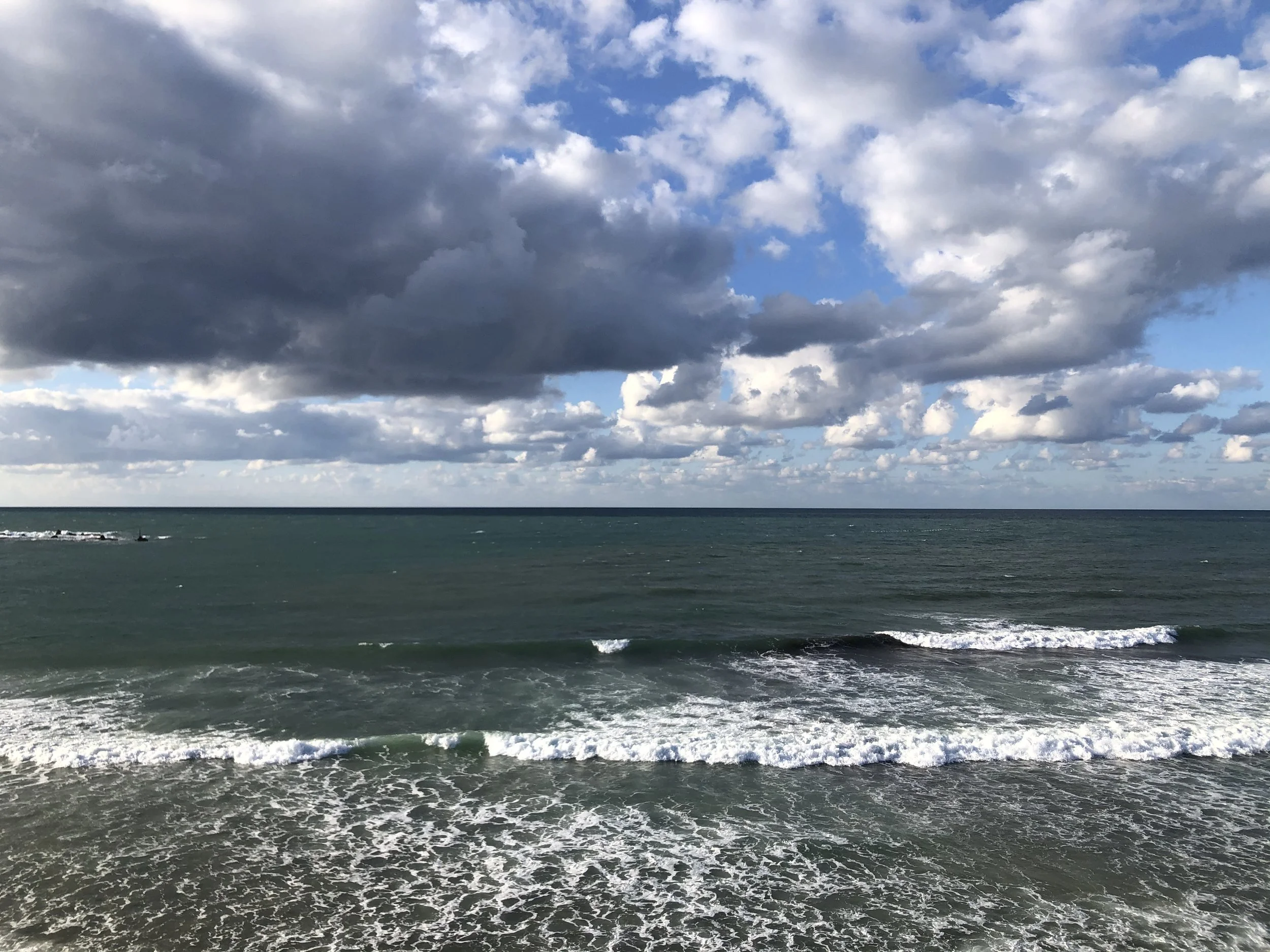 View from Jaffa’s Givat Aliyah Beach looking out over the open Mediterranean, with waves and clouds symbolizing expansion and stepping into a larger horizon.