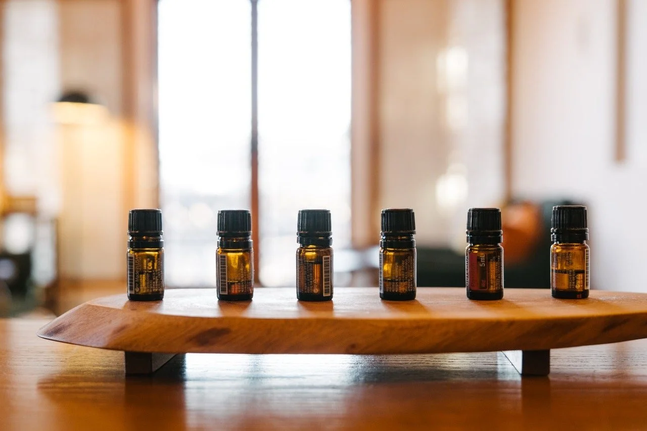 Korean calligraphy tools, including ink jars, brushes, colors and a ceramic ink rest on a wooden table.