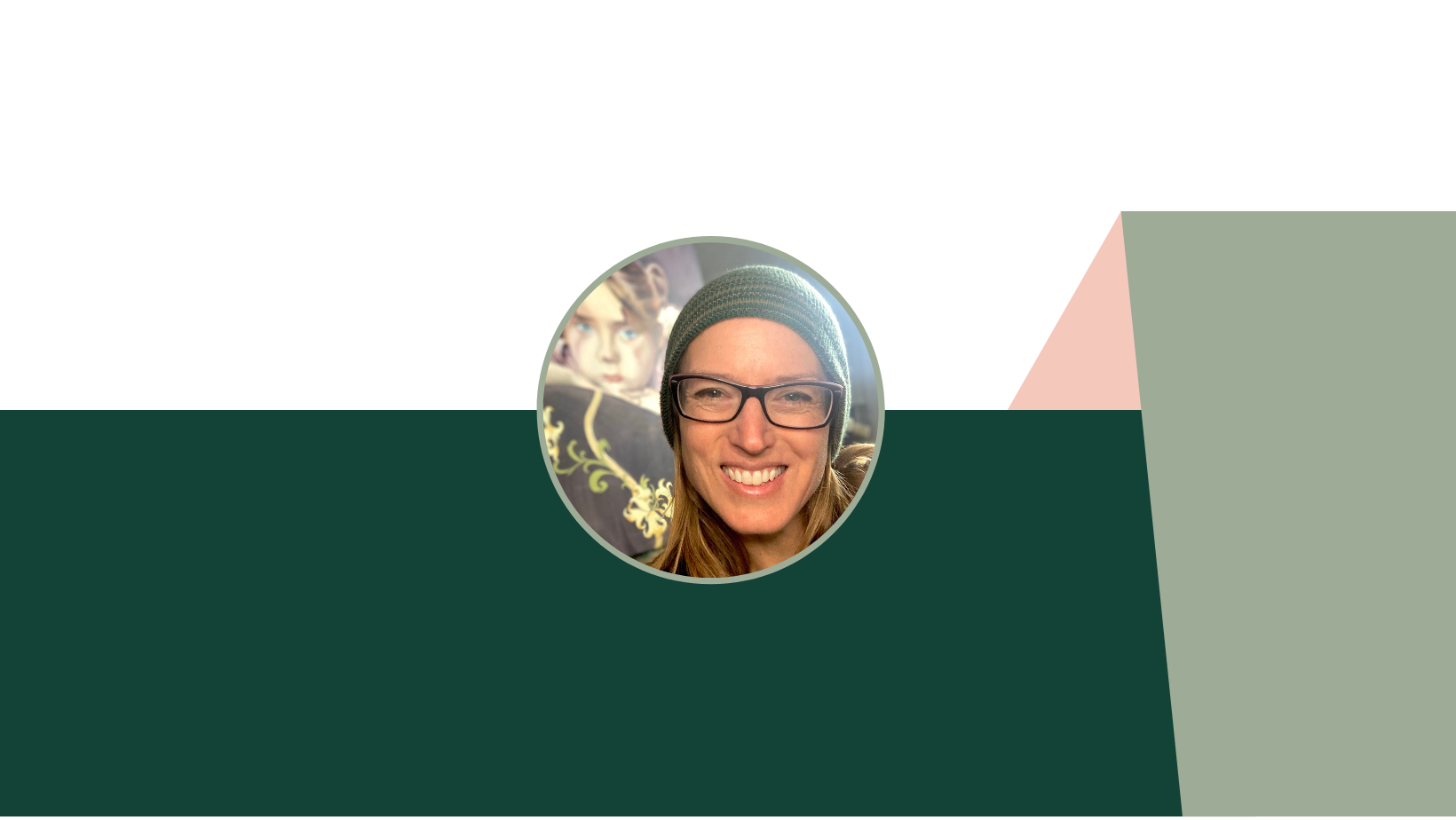 A woman smiling, wearing glasses and a beanie, with blurred background including a colorful mural.