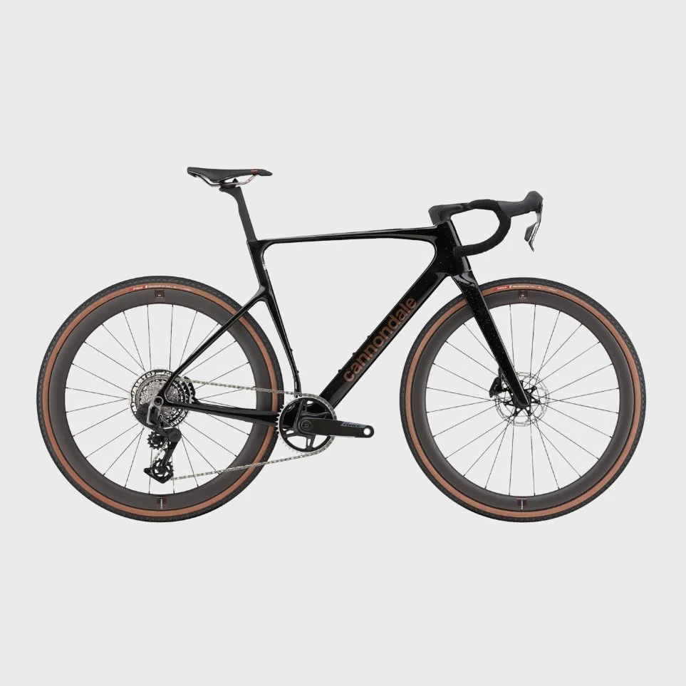 Black Cannondale road bike with tan tires on a plain light gray background