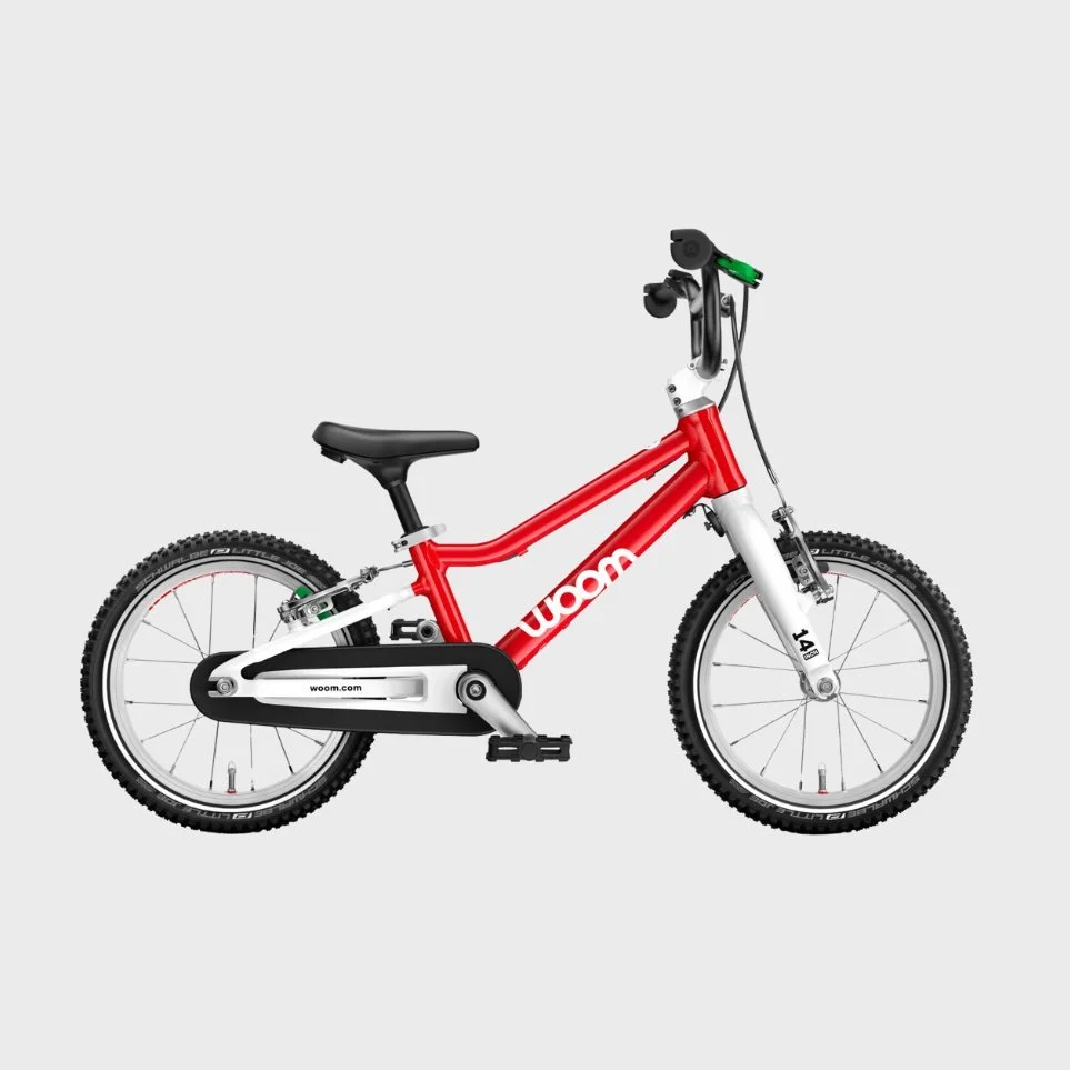 Red and white kids' bicycle with training wheels and black seat against a plain background.