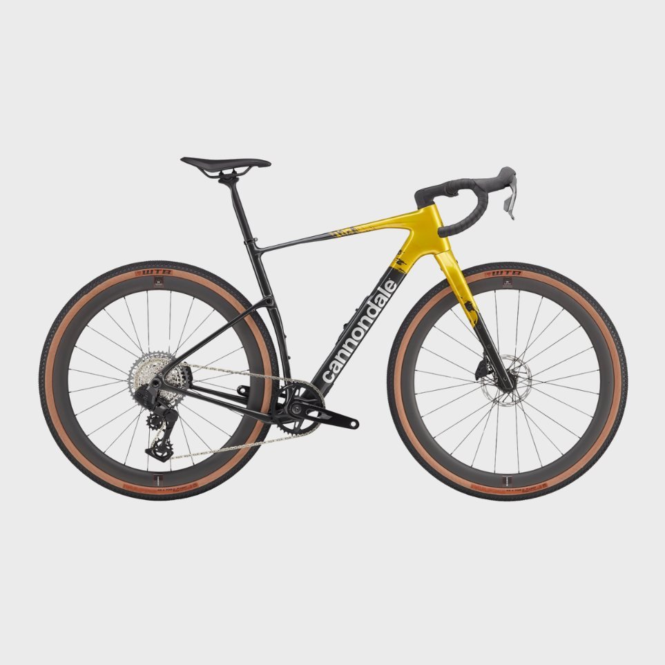 A Cannondale mountain bike with black and yellow frame and tan tires, displayed against a plain background.
