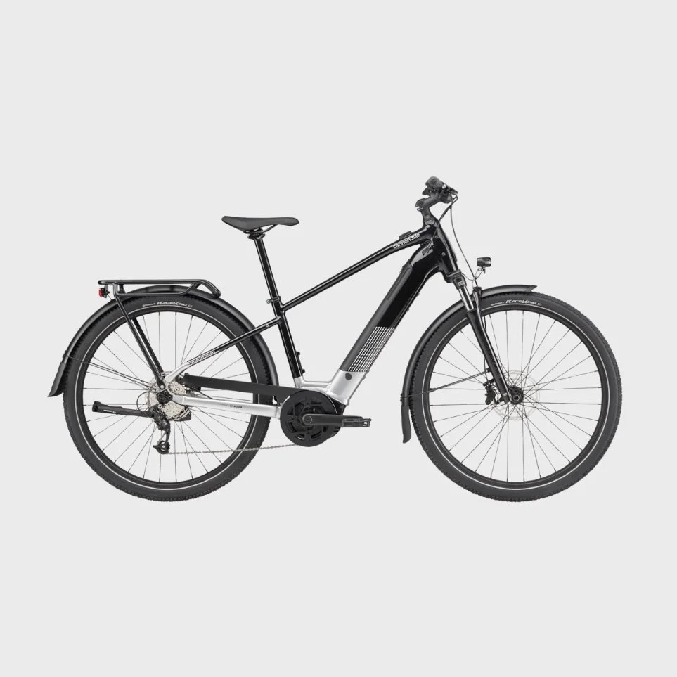 A black electric mountain bike with a rear rack, front suspension, and a mid-drive motor on a light gray background.