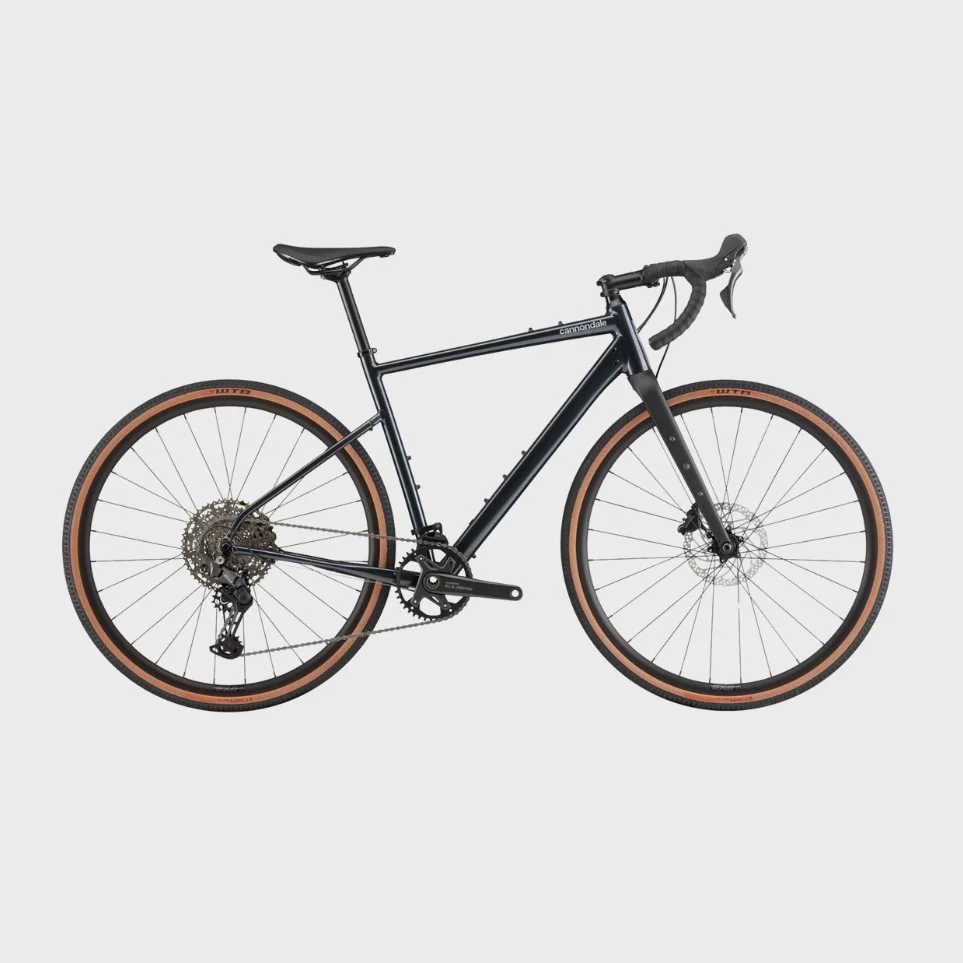 A black Cannondale mountain bike with tan sidewall tires against a plain white background.