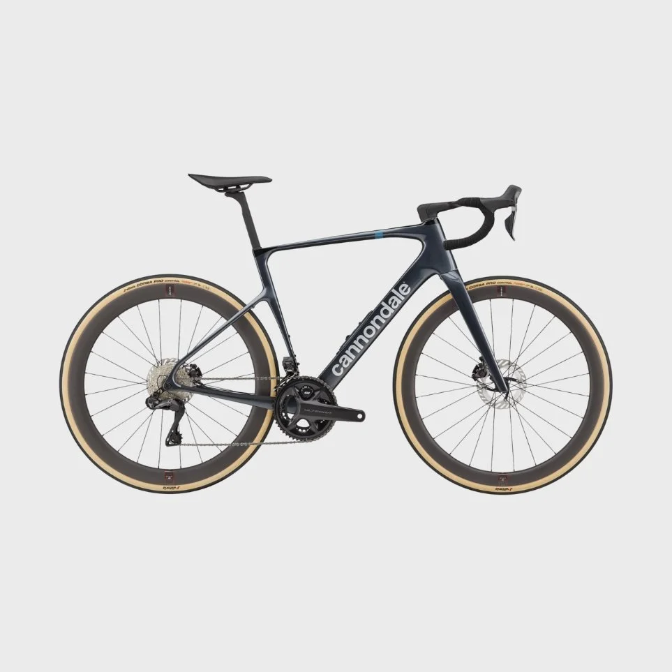Black Cannondale road bike with tan tires on a light gray background.