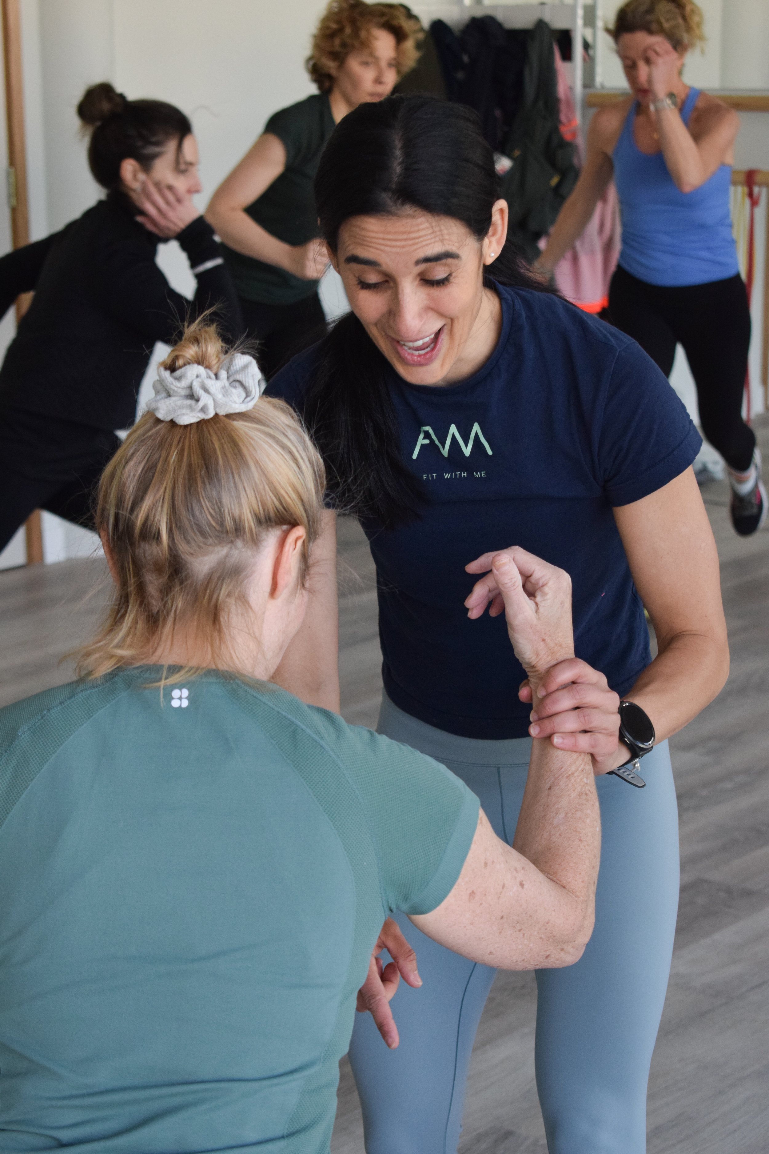 Two People Doing Box Jumps In Class