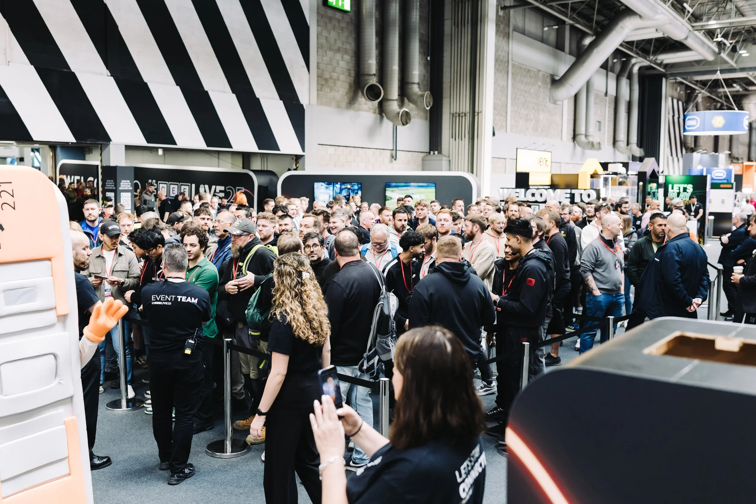 Crowd of people at a busy indoor event or convention.
