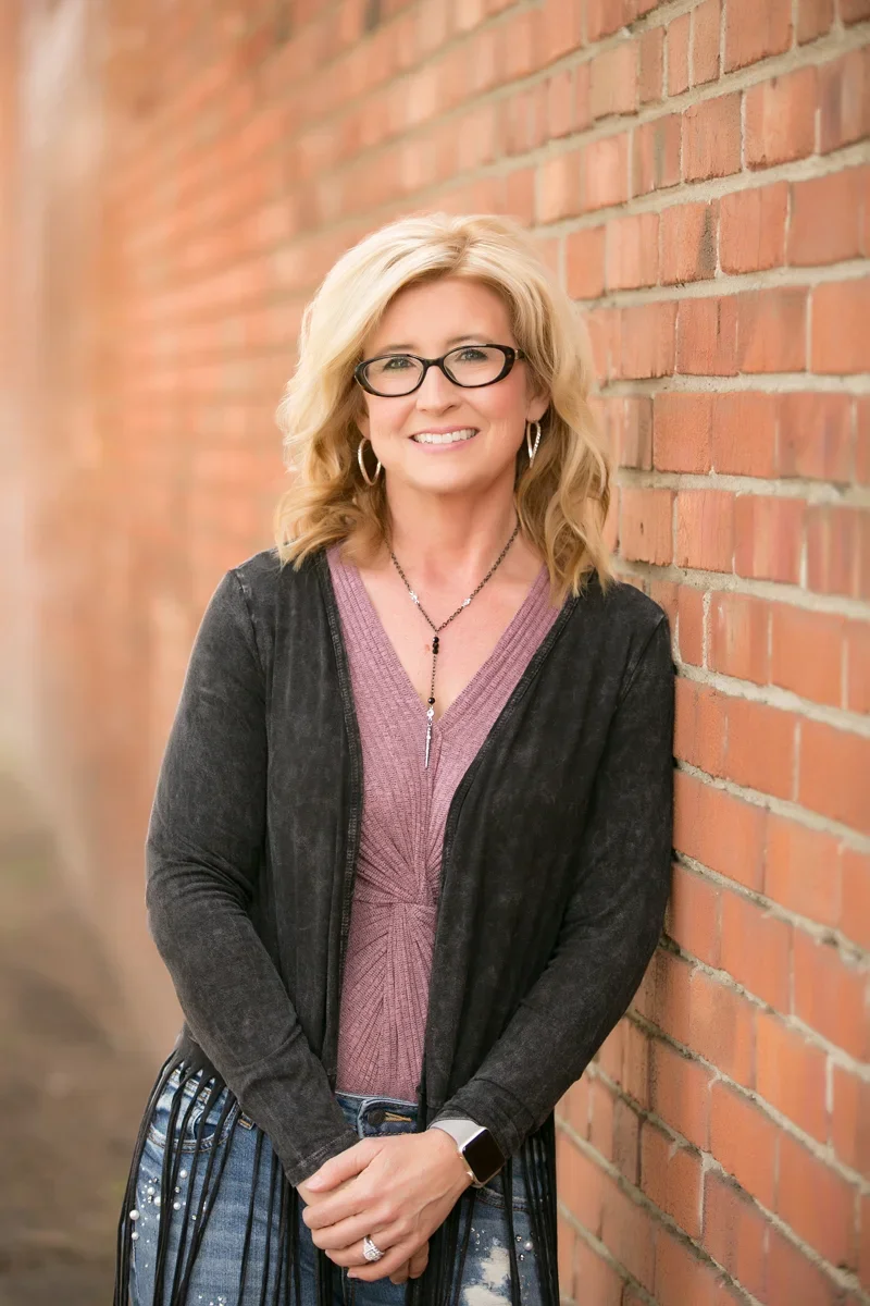 Dr. Angela Banks standing against wall